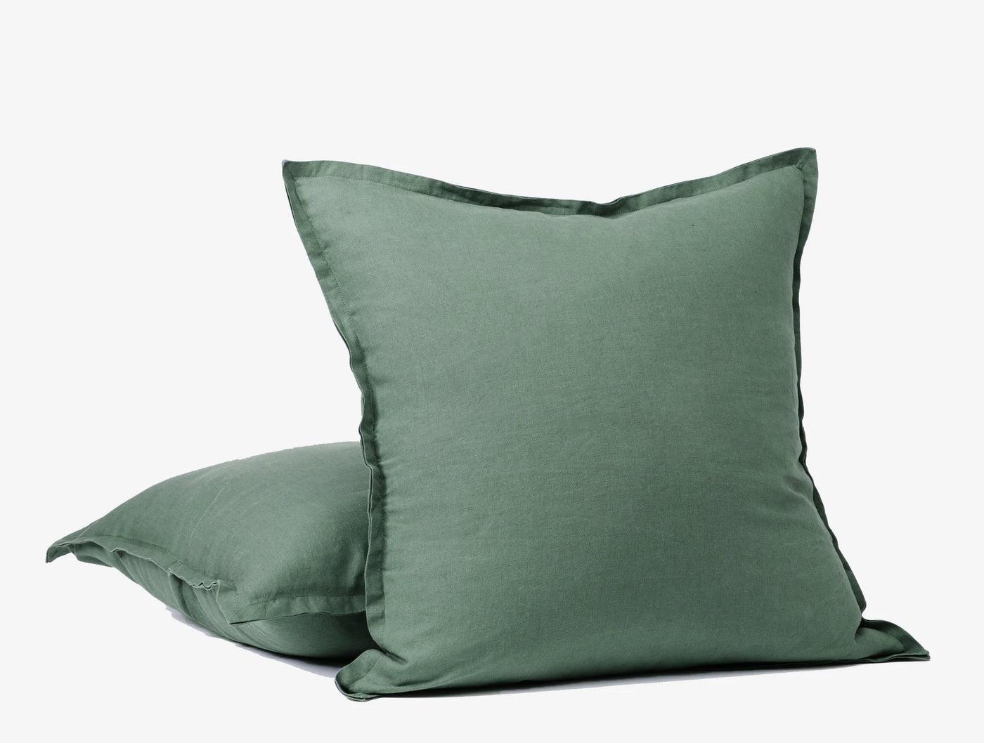 Coyuchi Relaxed Linen decorative pillow covers in sage green, stacked pair with flanged edges.