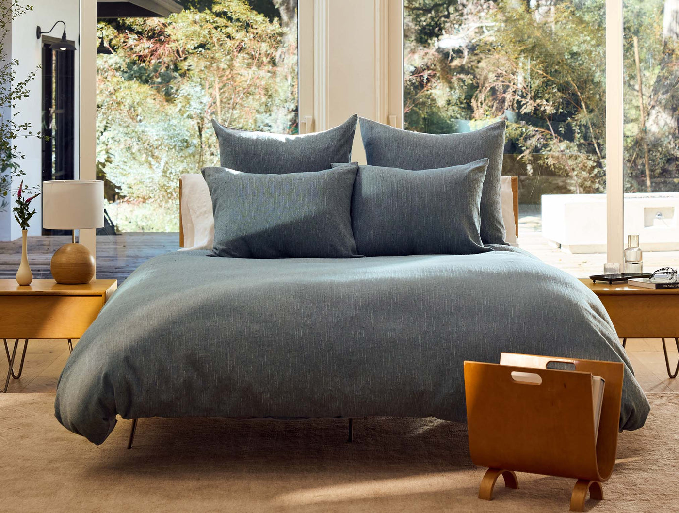 Coyuchi Toro Canyon duvet cover in slate blue on a styled bed with natural light.