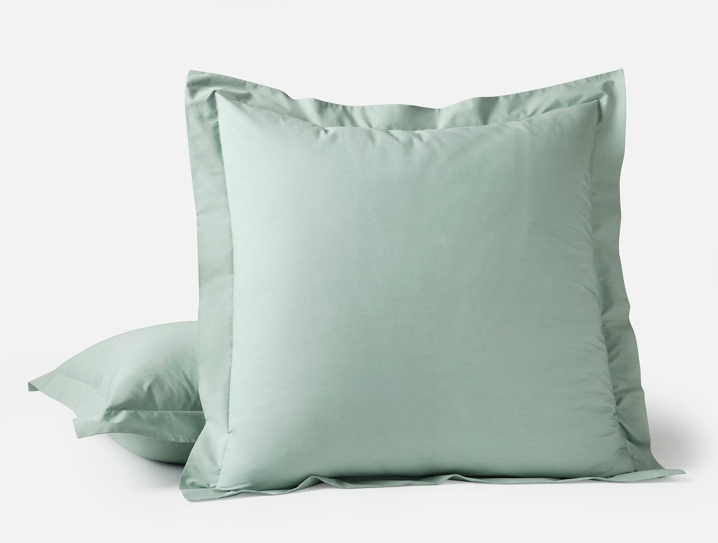 Sage green euro sham with flange border, stacked with standard sham on white background.