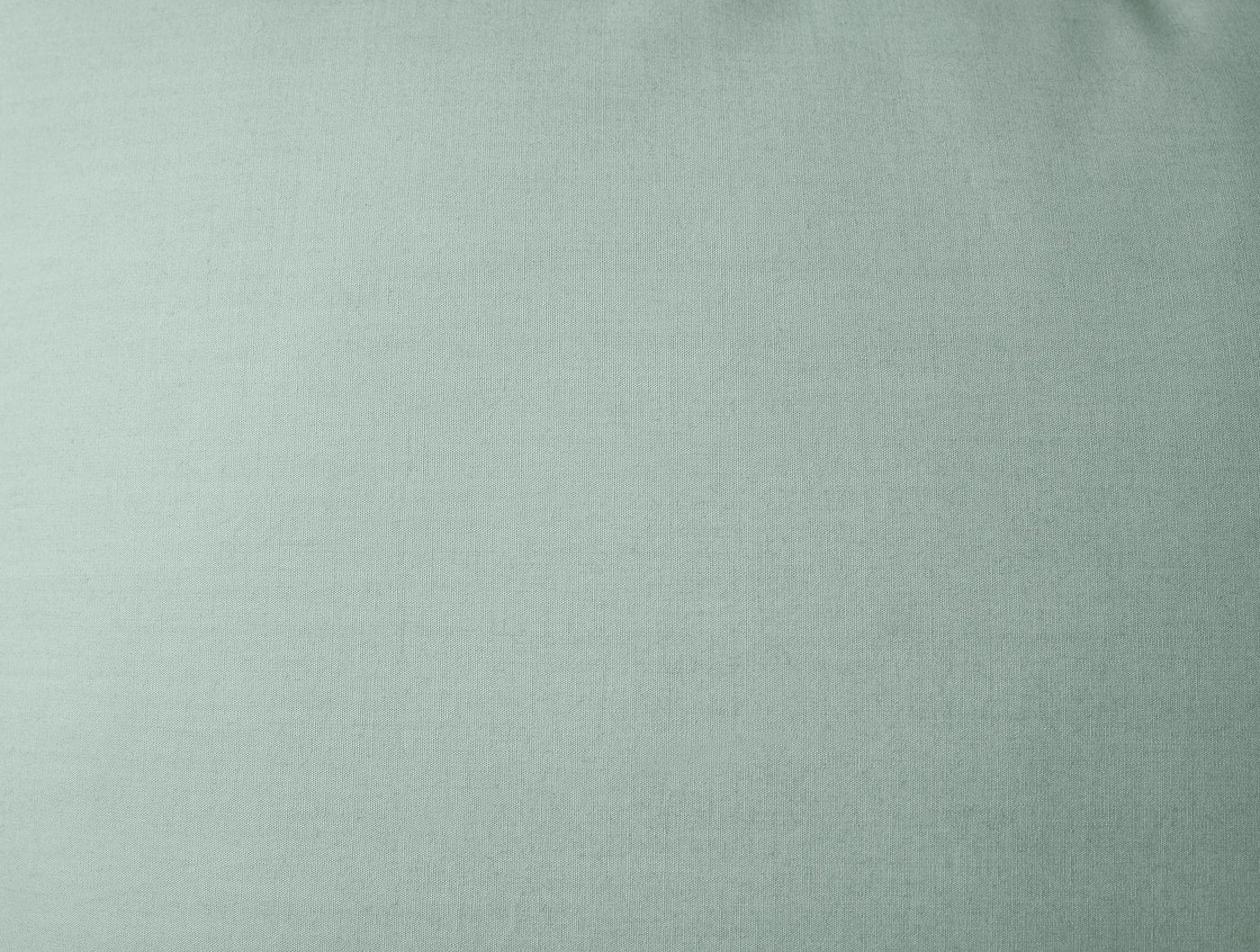 Close-up of Coyuchi Refined Percale sham in sage green, showing smooth percale weave texture.