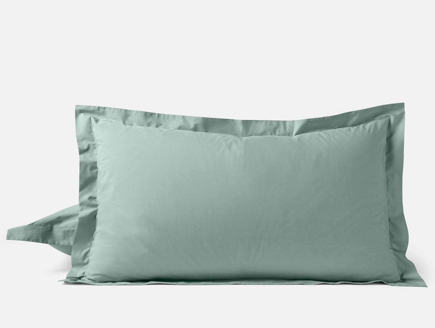 Two sage Coyuchi Refined Percale pillow shams stacked, with wide Oxford border trim.