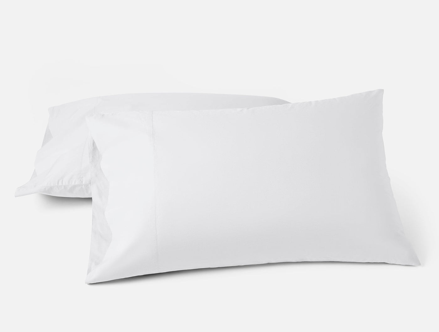 Coyuchi Refined Percale pillowcase pair in white, two pillows stacked on neutral background.