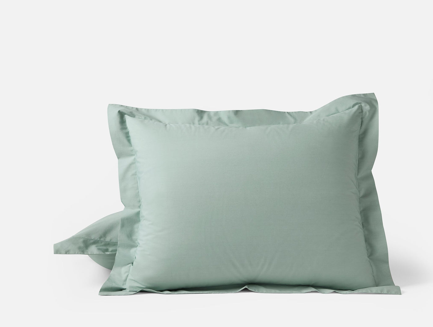 Sage green Coyuchi Refined Percale pillow sham pair with tailored flange detail.