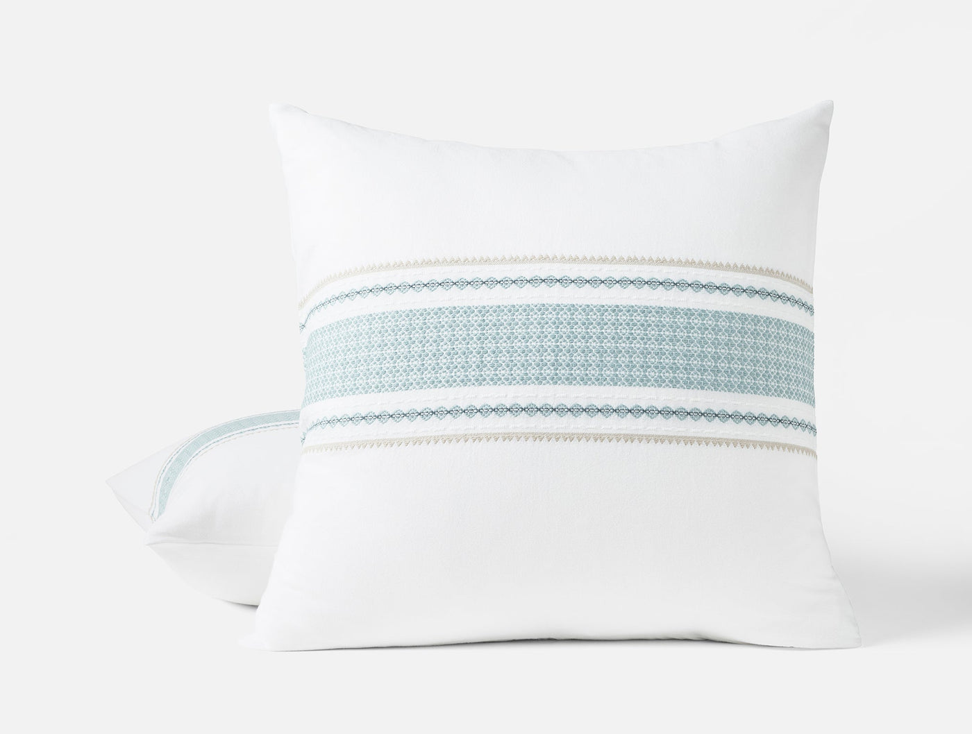 Close-up of Coyuchi Cabrillo sham showing aqua and ivory woven stripe detail on white cotton.