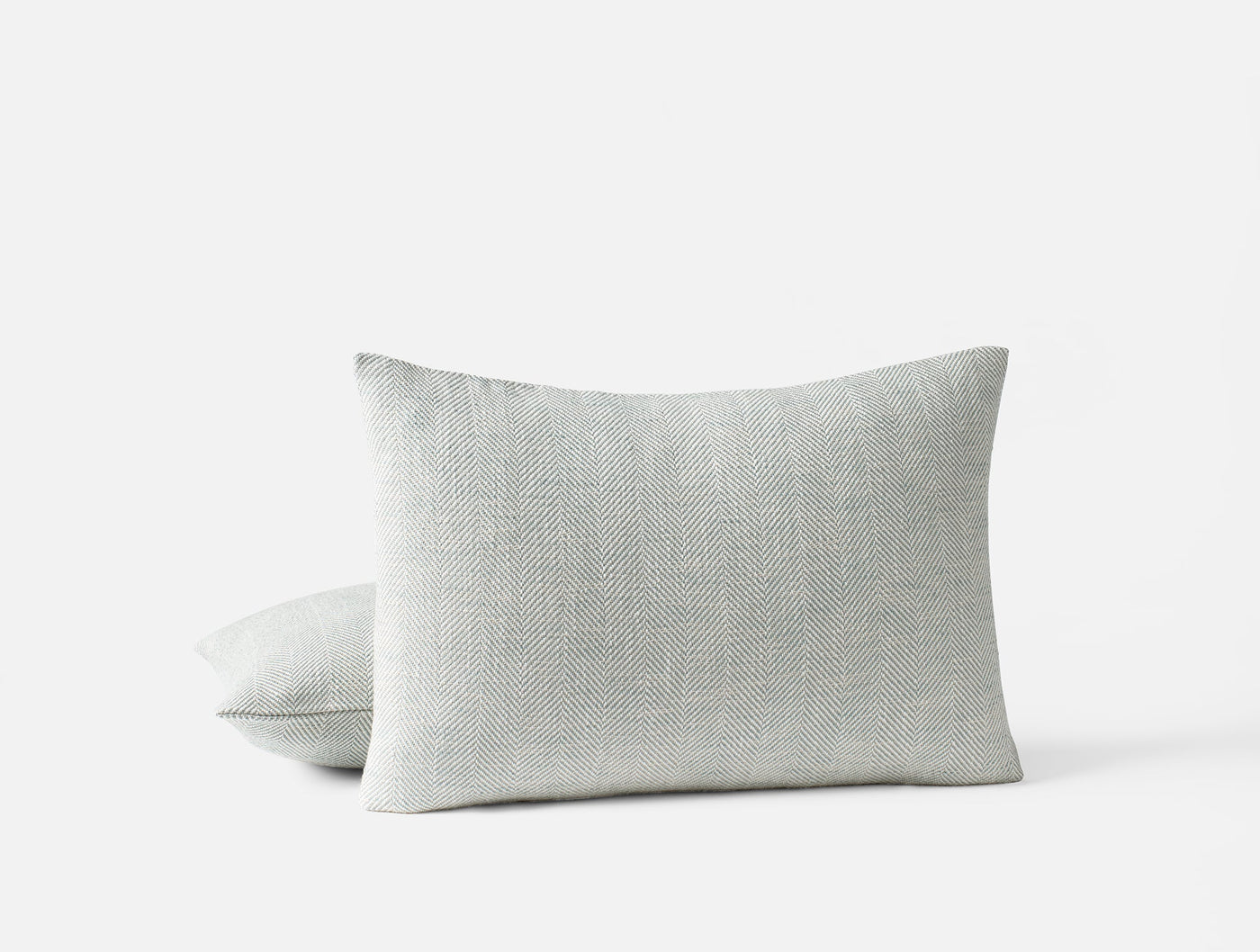 Coyuchi Canyon decorative pillow cover in pale grey, textured weave, stacked pair view.