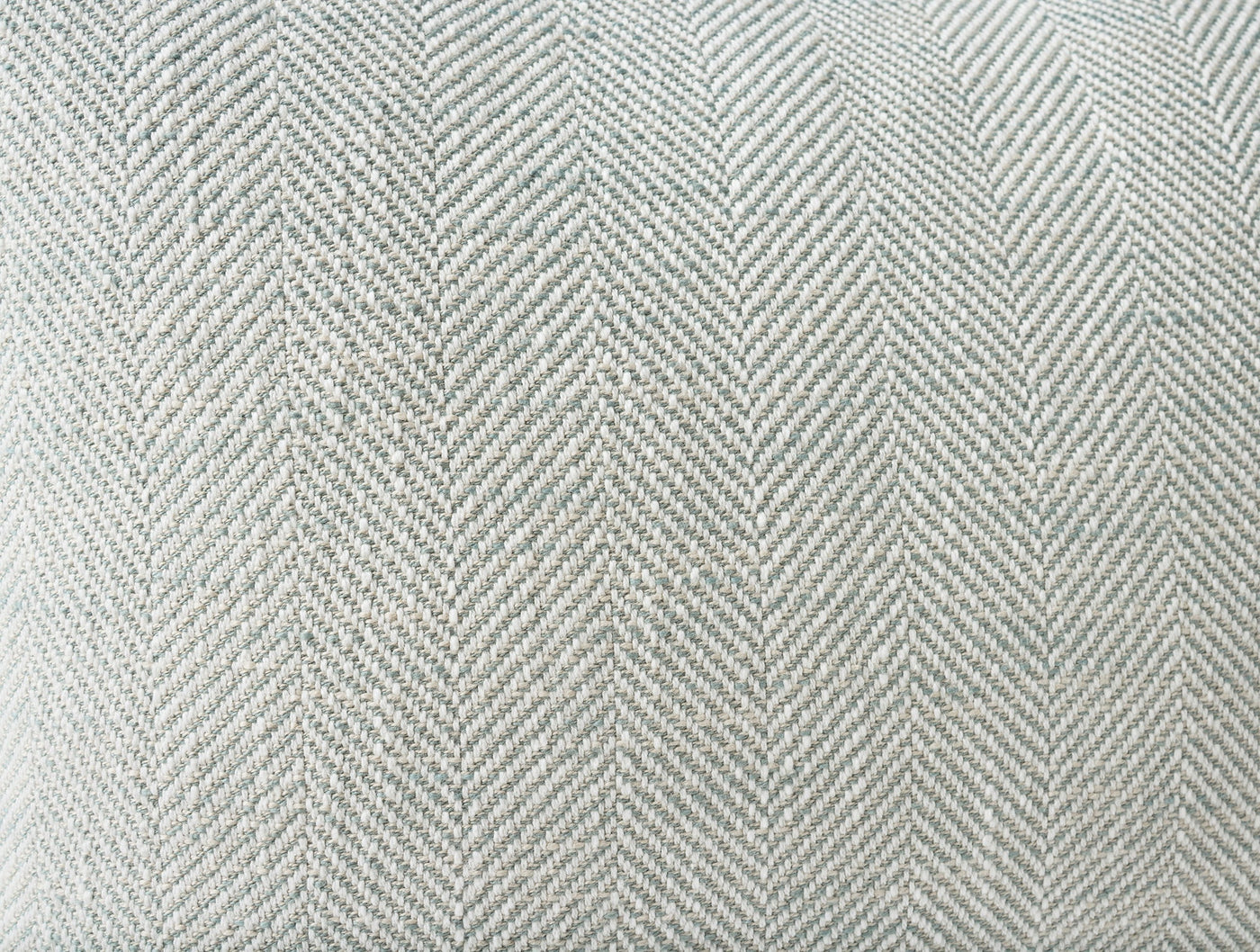 Close-up of Coyuchi Canyon pillow's sage herringbone weave texture.