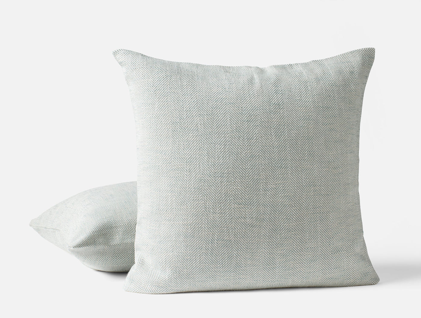 Two Coyuchi Canyon linen throw pillow covers in mist, showing front and angled side views.