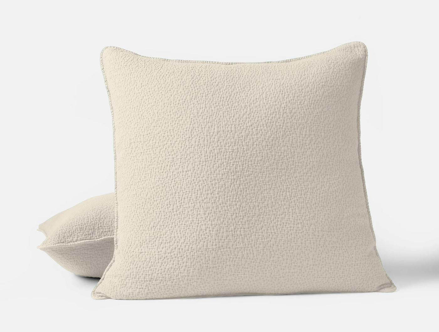Ivory boucle-textured pillow sham, front and angled view showing nubby weave detail.