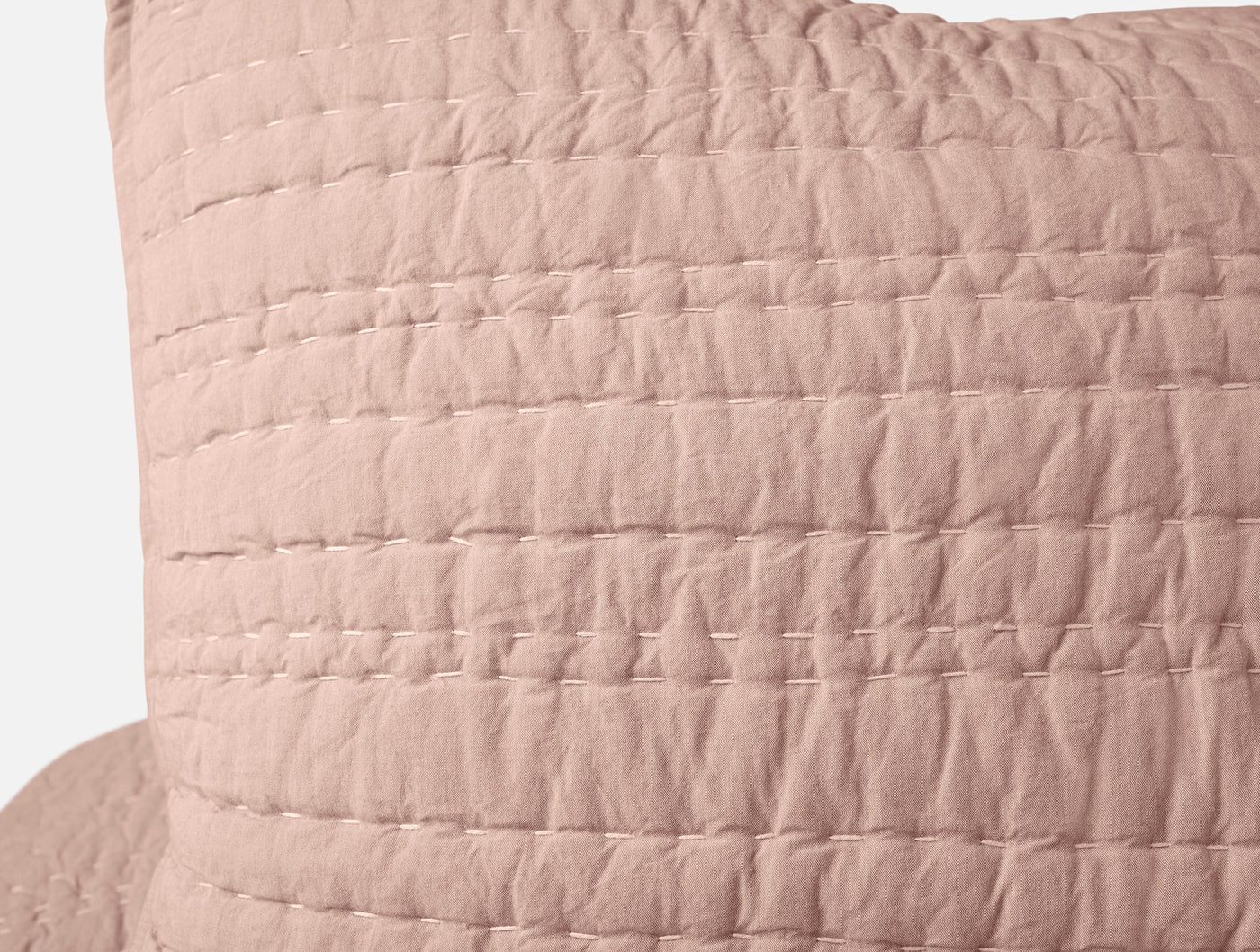 Close-up of blush Channel Handstitched sham showing quilted channel stitching texture.