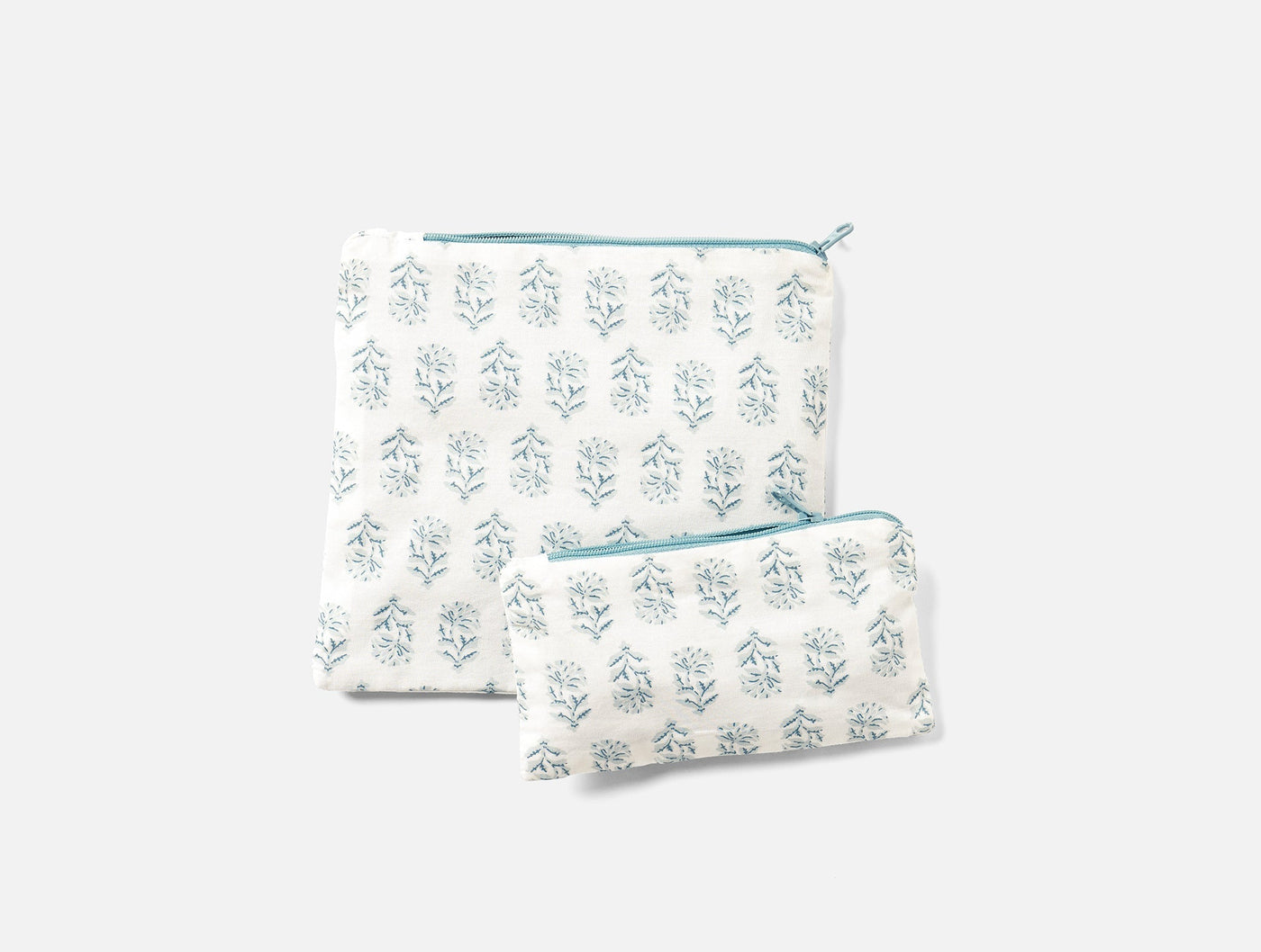 Coyuchi Conserve snack bag set in white with teal block-print floral pattern, two sizes shown.