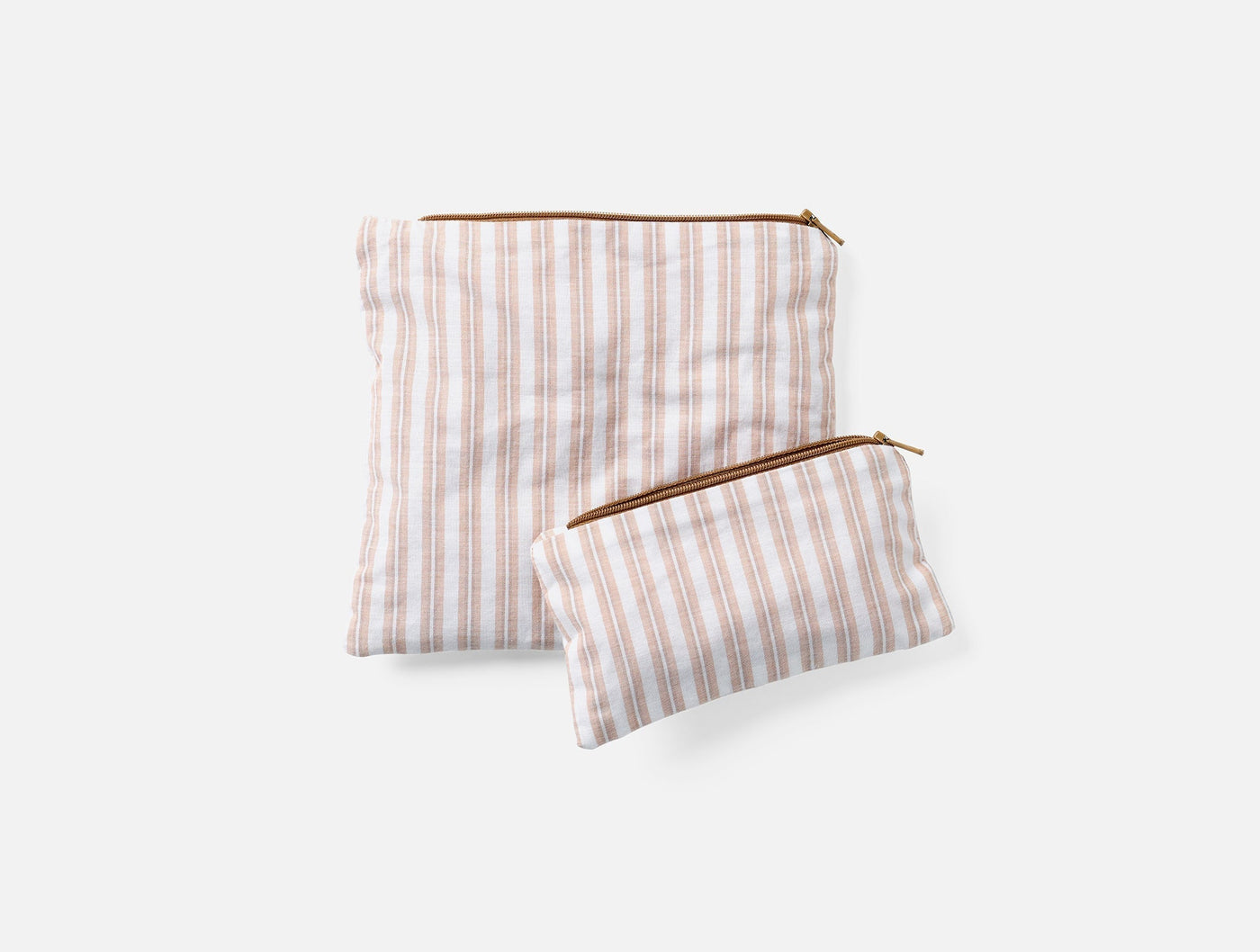 Close-up of two Coyuchi striped linen snack bags with brass zippers, large and small.
