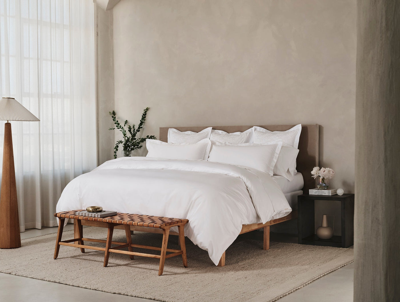 Coyuchi Heirloom Sateen duvet cover in white, styled on a made bed in a neutral bedroom.