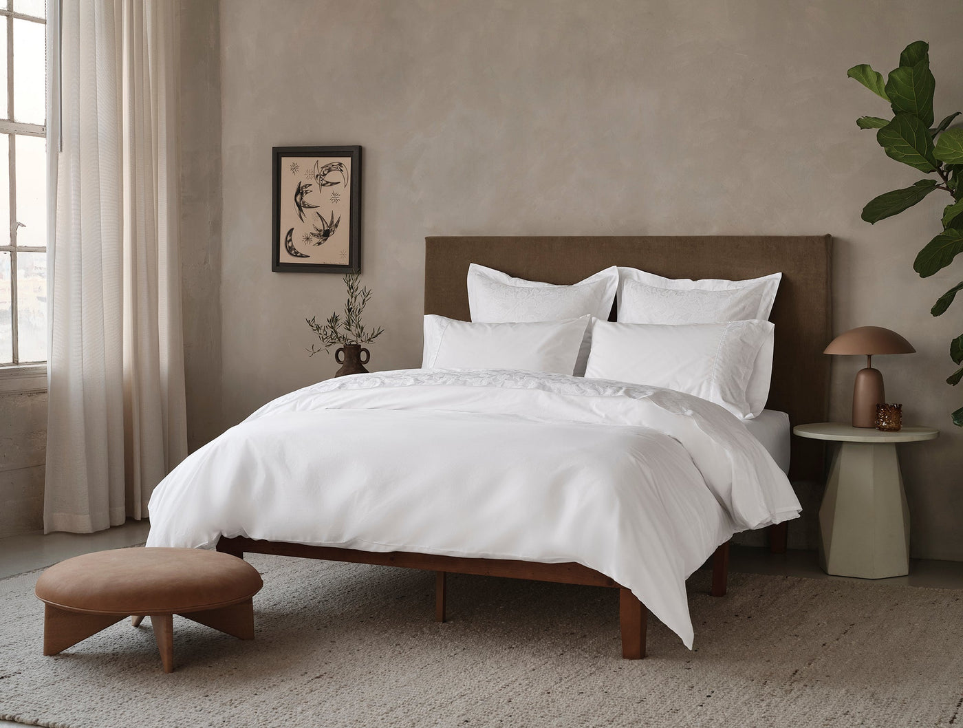 Coyuchi Heritage Percale duvet cover in white styled on bed in warm neutral bedroom.