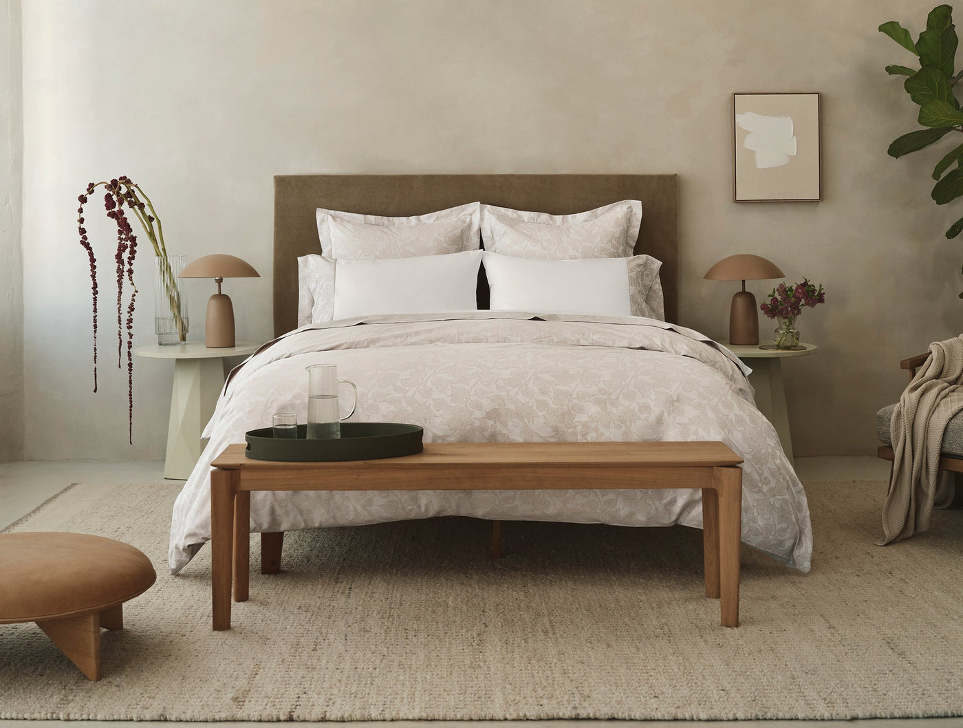 Styled bedroom scene with Coyuchi Heritage Percale Jacquard duvet in soft neutral tones.
