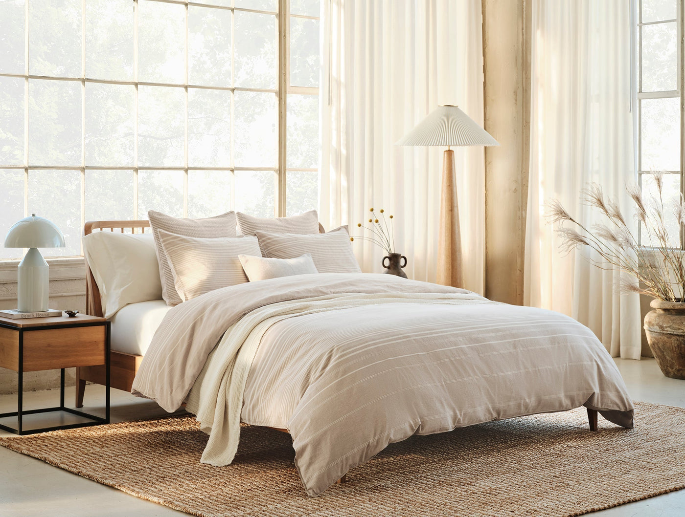 Coyuchi Little Sur Stripe duvet set styled on bed in warm neutral bedroom with natural light.