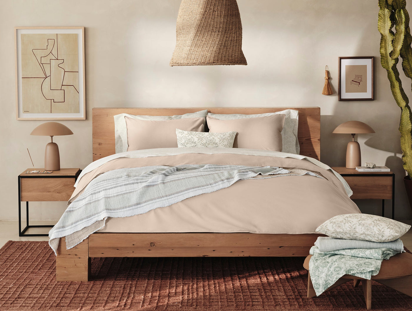 Coyuchi Topanga Matelassé blanket draped across a styled bed in a warm neutral bedroom.