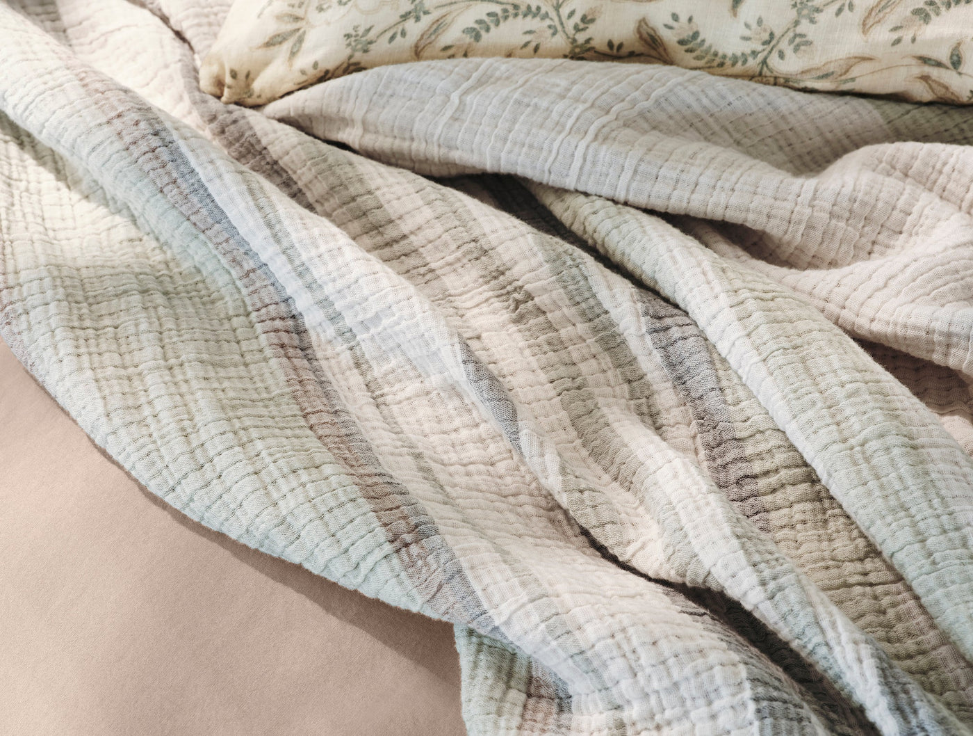 Close-up of Coyuchi Topanga Matelassé blanket in sage, showing crinkled organic cotton texture.