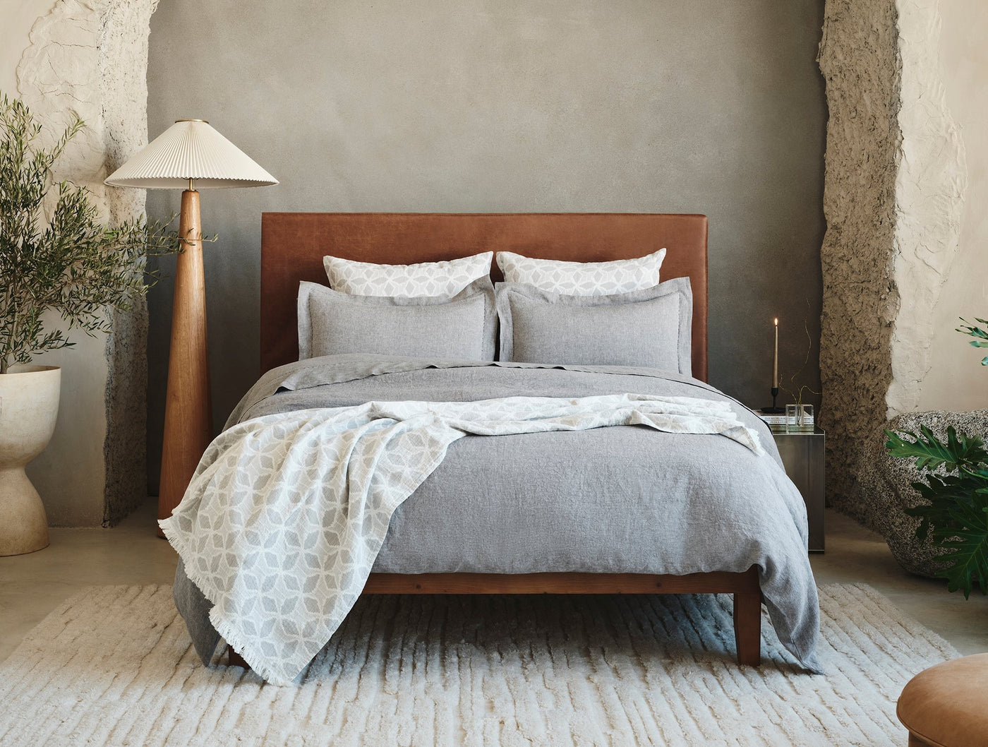 Styled bedroom scene with Coyuchi Relaxed Linen duvet in grey on a walnut bed.
