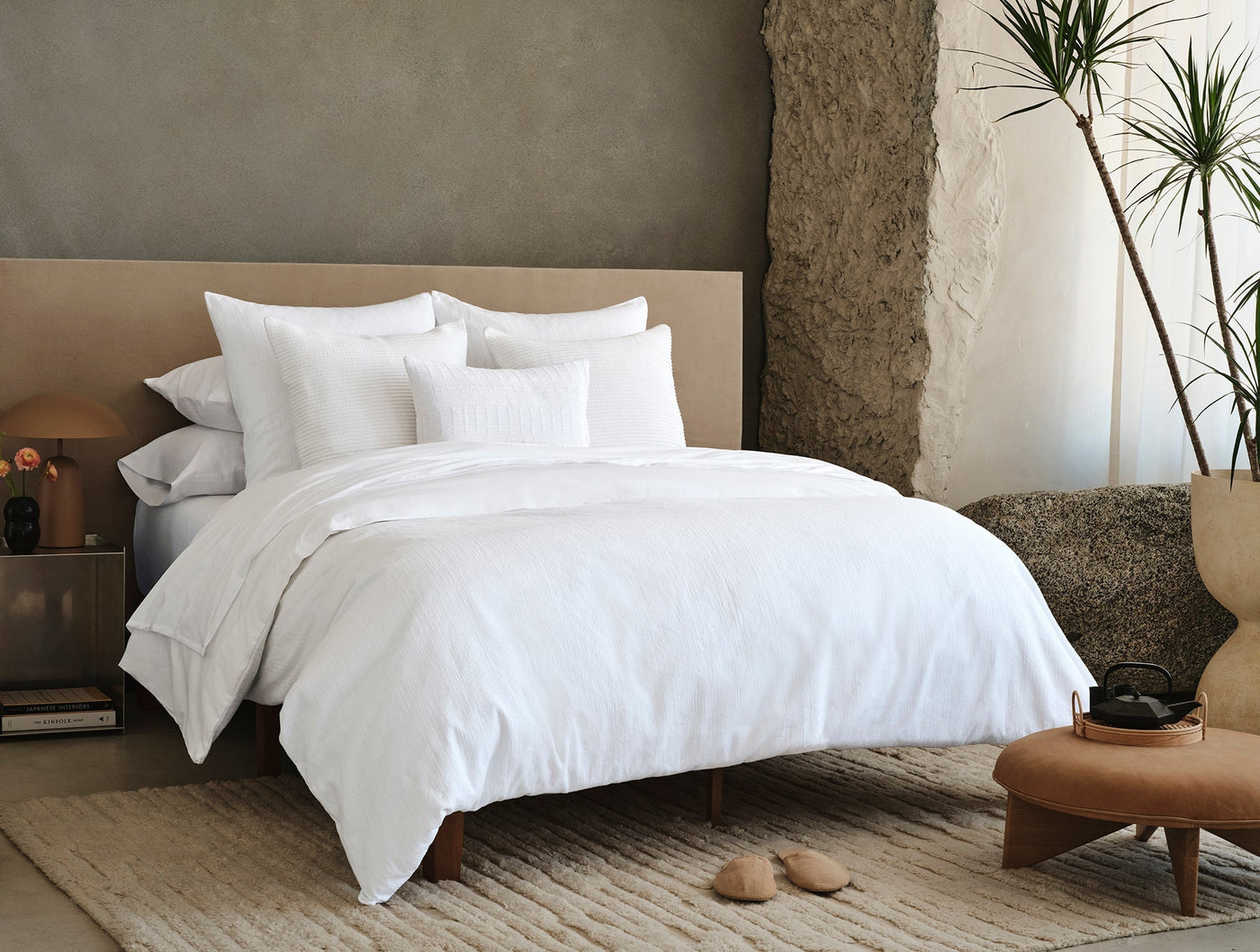 Coyuchi Toro Canyon duvet cover styled on a bed in a warm neutral bedroom setting.