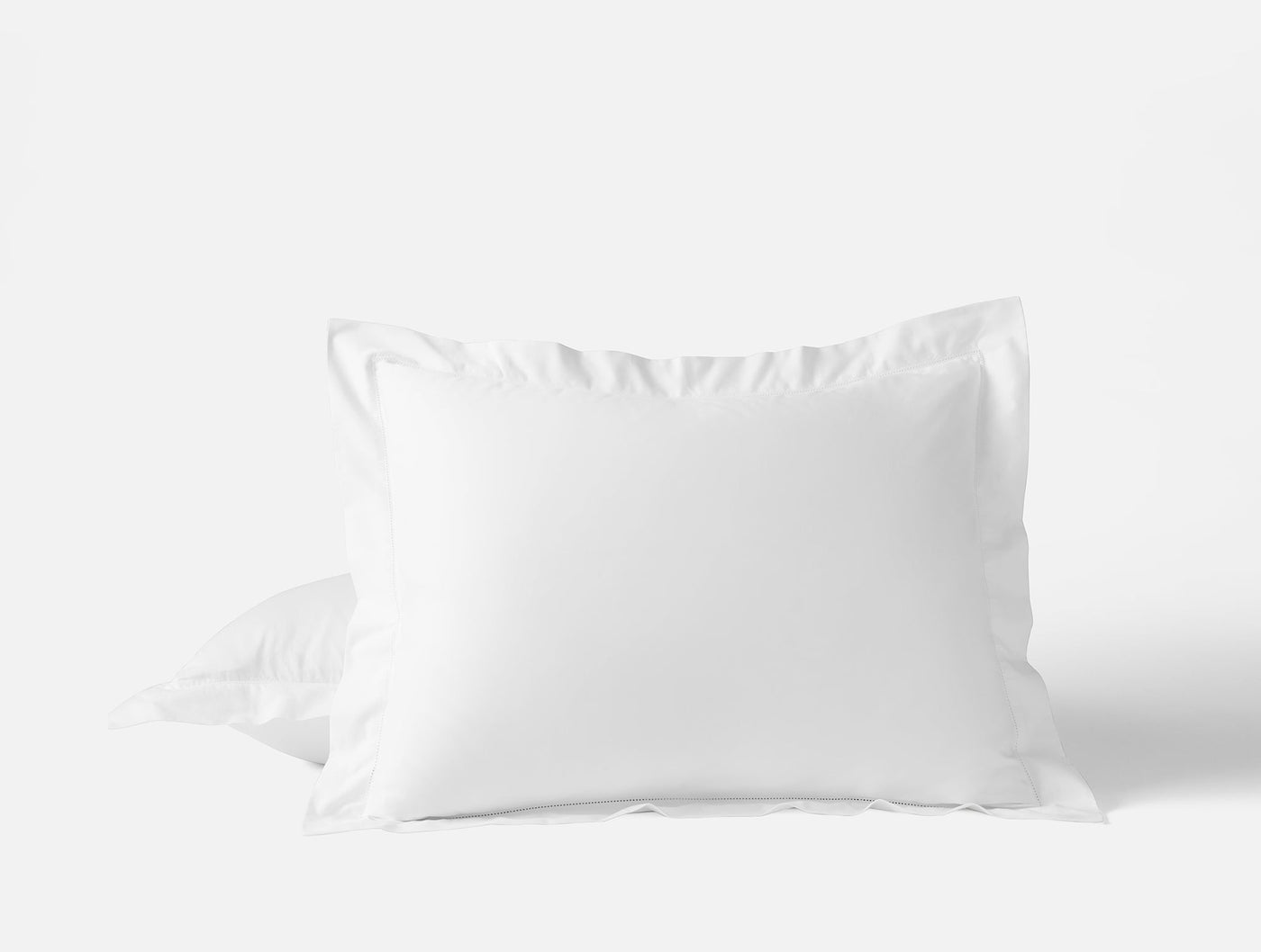 Coyuchi Heritage Percale pillow sham in white with classic flange border detail.