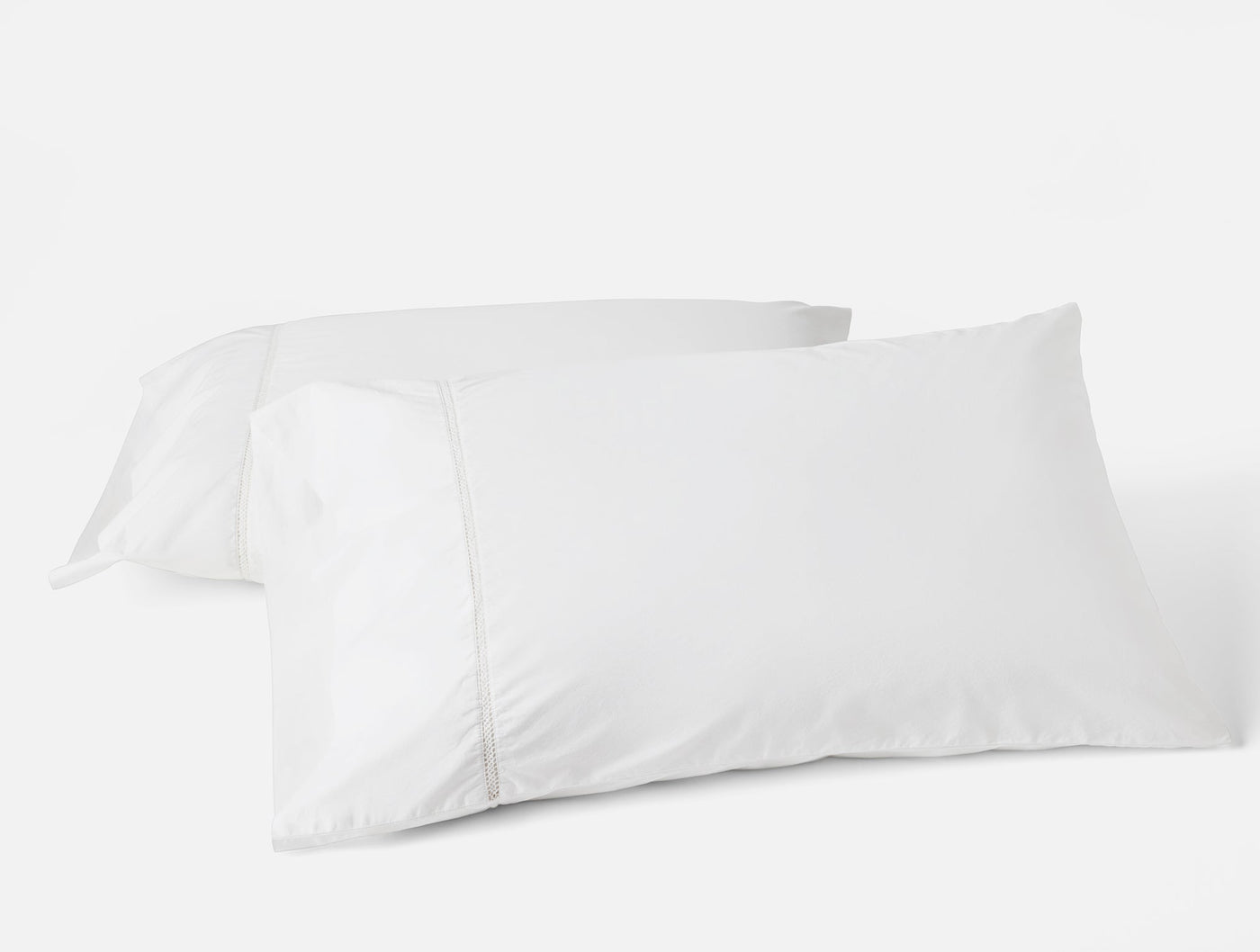 Coyuchi Lattice Percale pillowcase pair in white, two pillowcases stacked on neutral background.