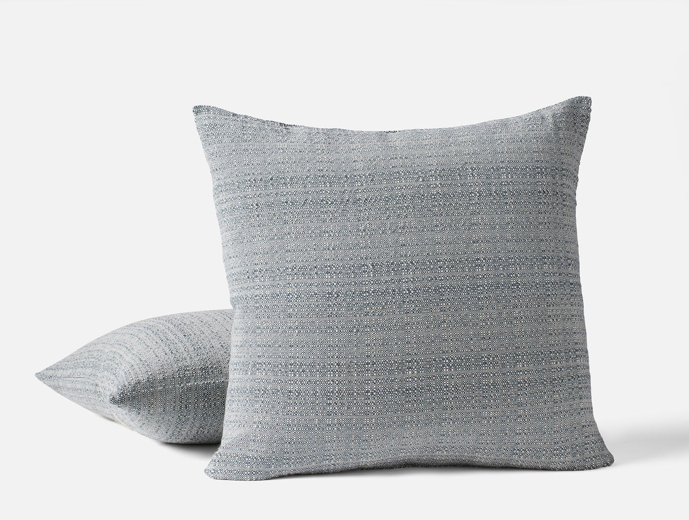 Coyuchi Lido pillows in slate blue, textured woven fabric, two sizes stacked.
