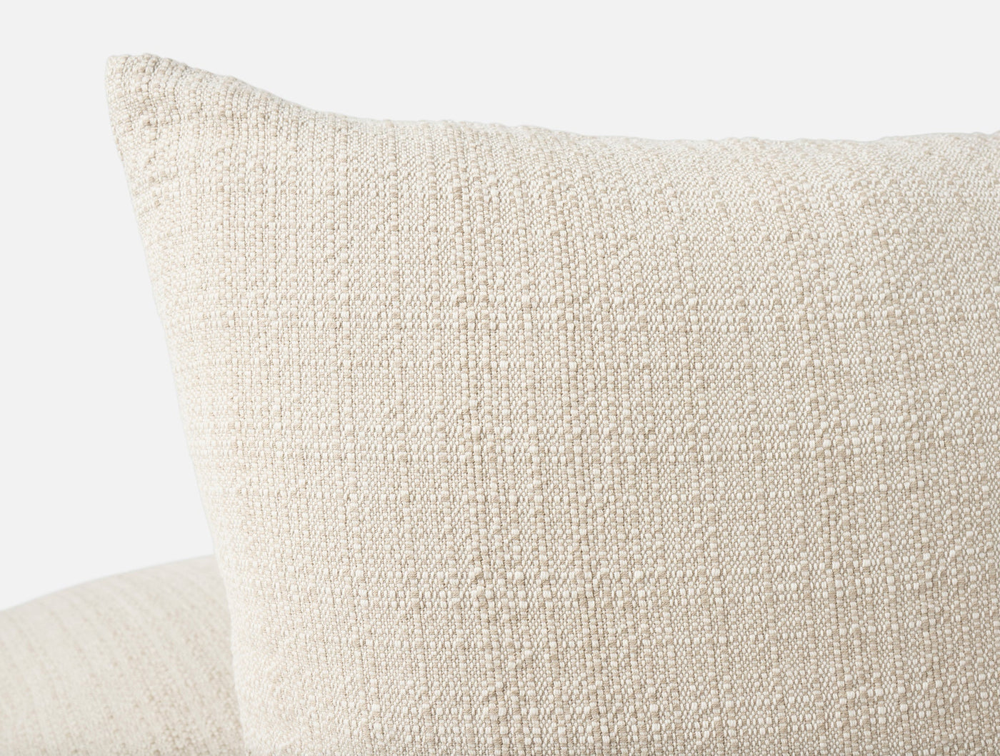 Close-up of Coyuchi Lido pillow cover corner in ivory, showing chunky woven texture.