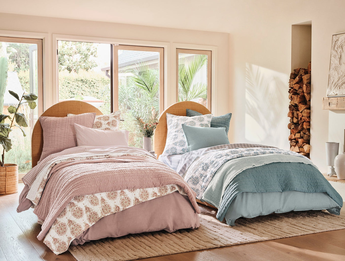 Two styled beds with Crinkled Percale duvet covers in dusty rose and slate blue, sunlit bedroom.