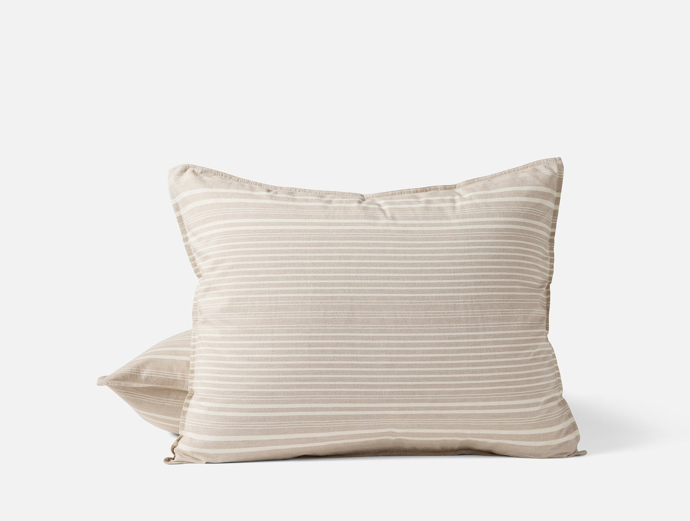Two stacked Coyuchi Little Sur Stripe pillowcases in natural with ivory horizontal stripes.