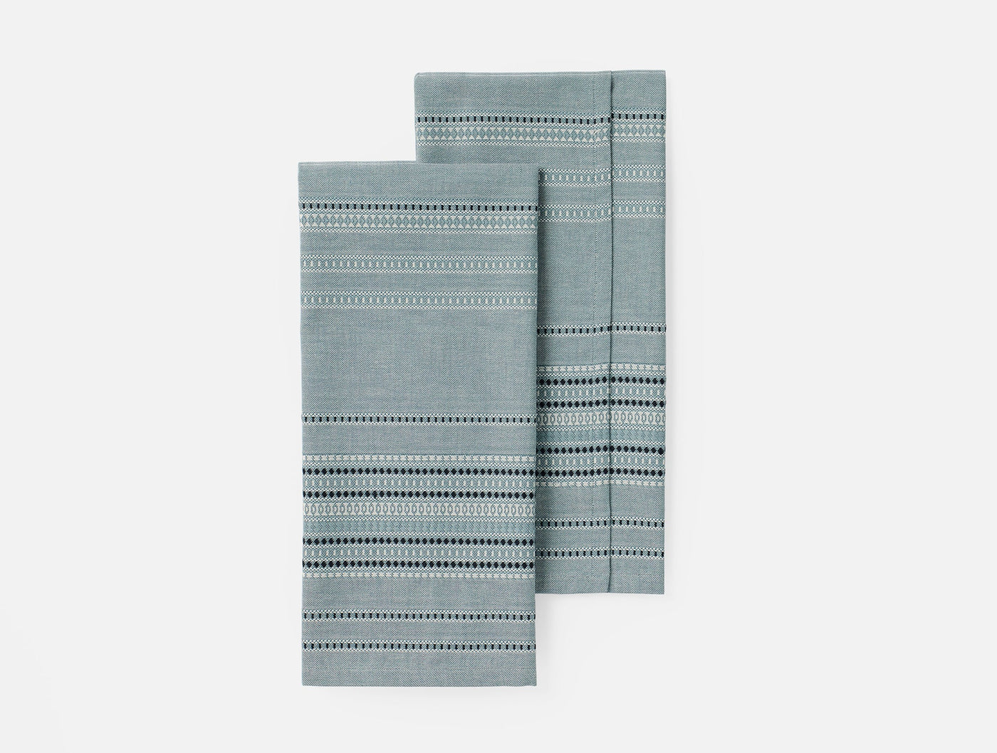 Coyuchi Lobos hand towels in slate, pair folded showing dotted stripe weave detail.