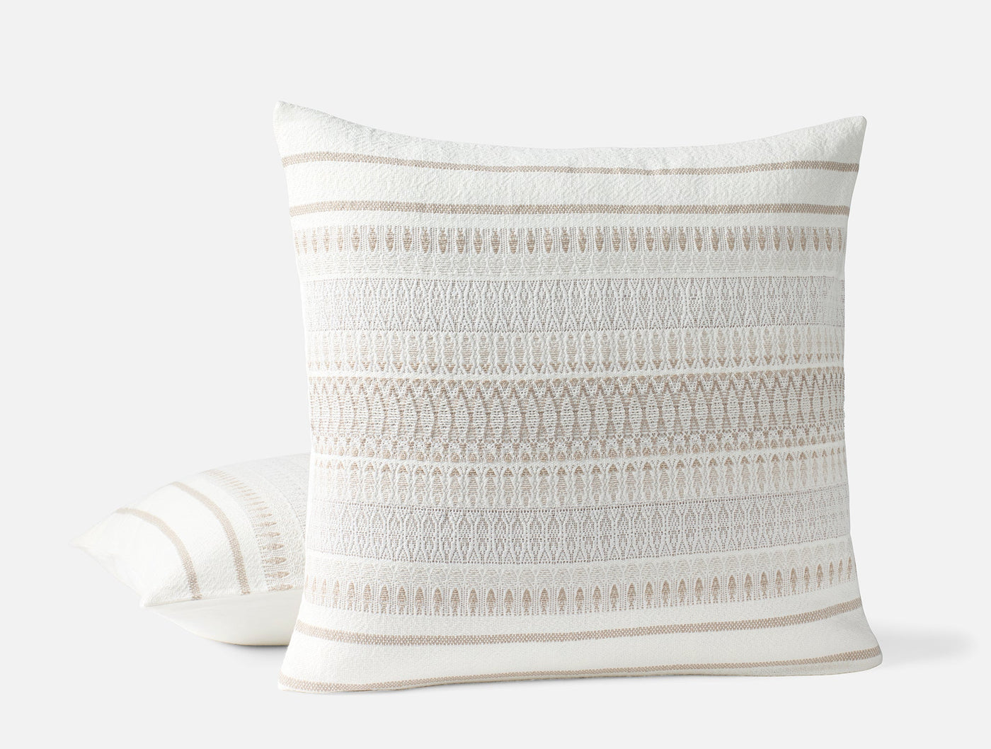 Close-up of Coyuchi Lost Coast pillow showing ivory textured stripe and fringe detail.