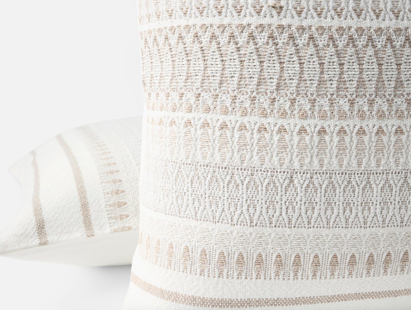 Close-up of Coyuchi Lost Coast pillow's ivory and tan woven geometric stripe texture.