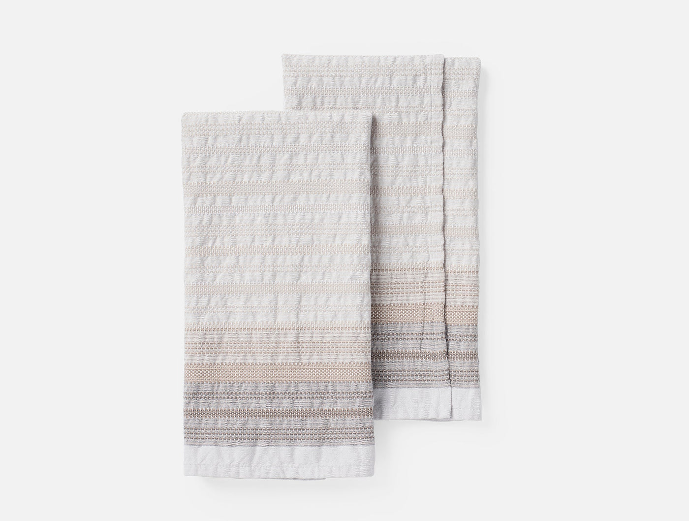 Coyuchi Magnolia hand towel pair, ivory with blush and grey striped embroidered detail.