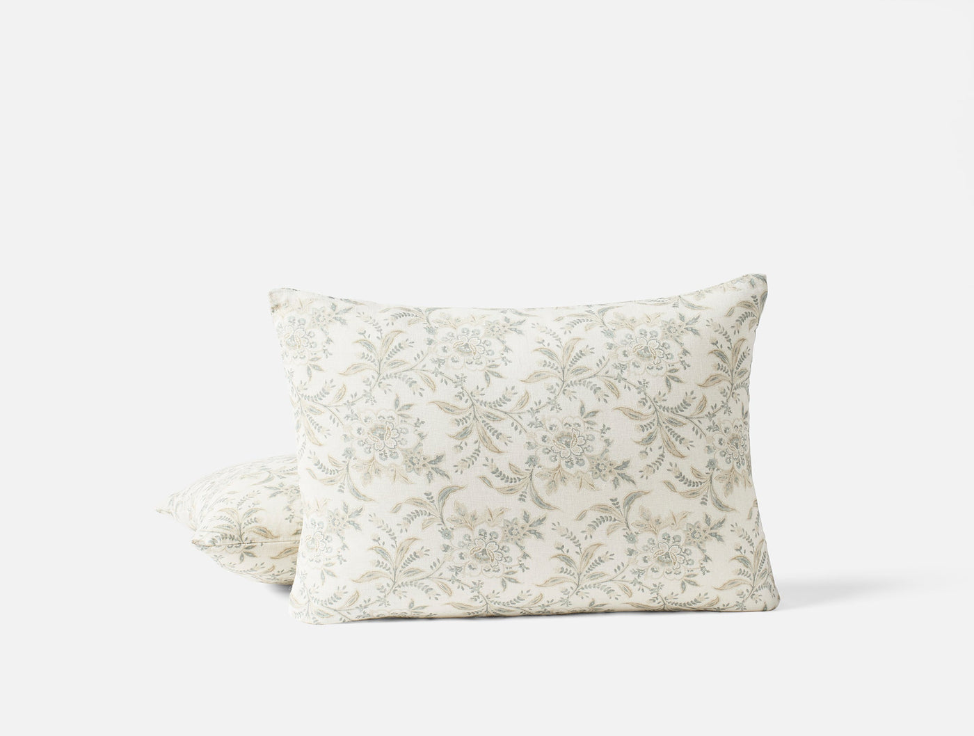 Coyuchi Marguerite Print pillow cover, ivory with sage floral toile pattern, two pillows stacked.