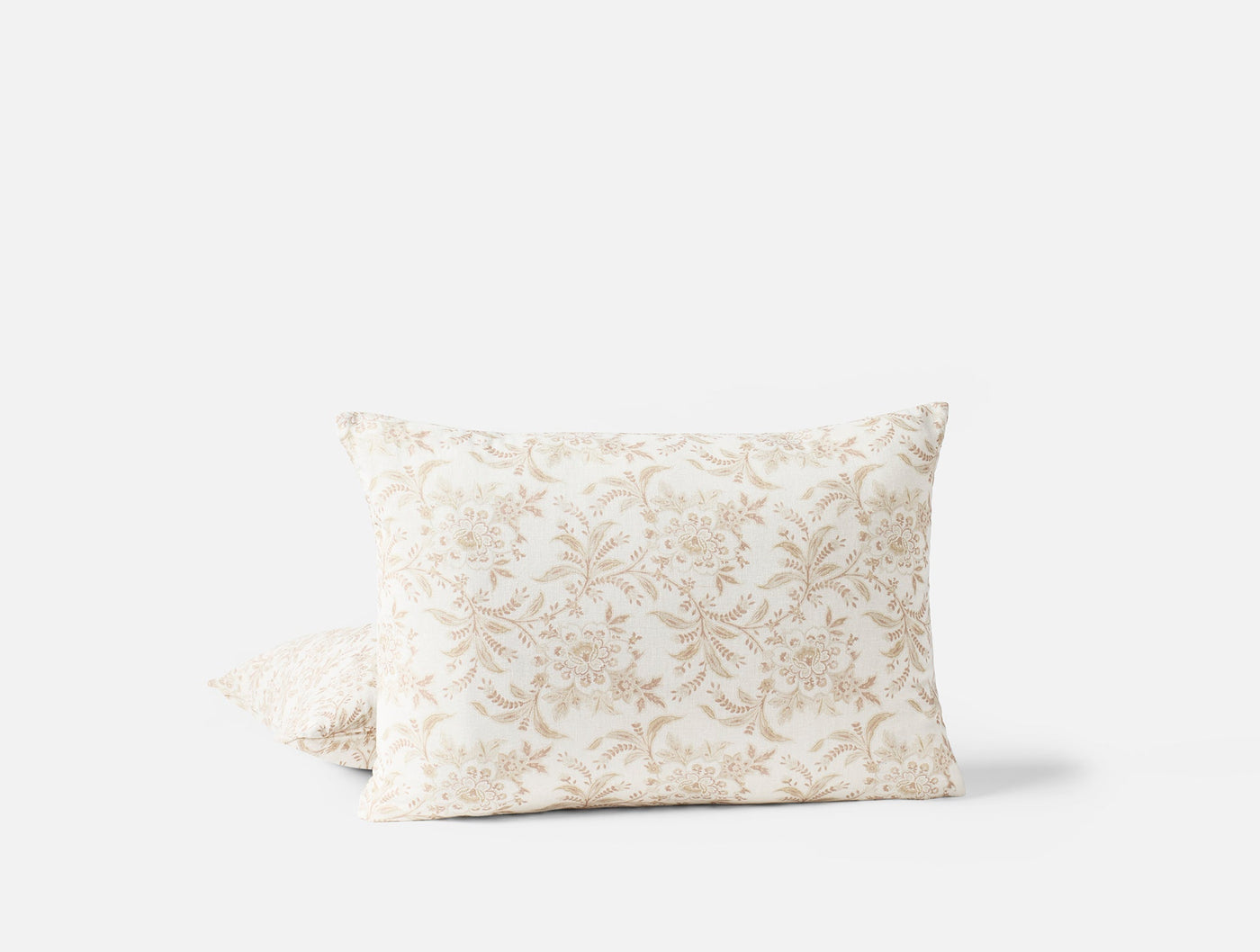 Coyuchi Marguerite Print pillow covers, ivory with champagne floral damask pattern, pair stacked.
