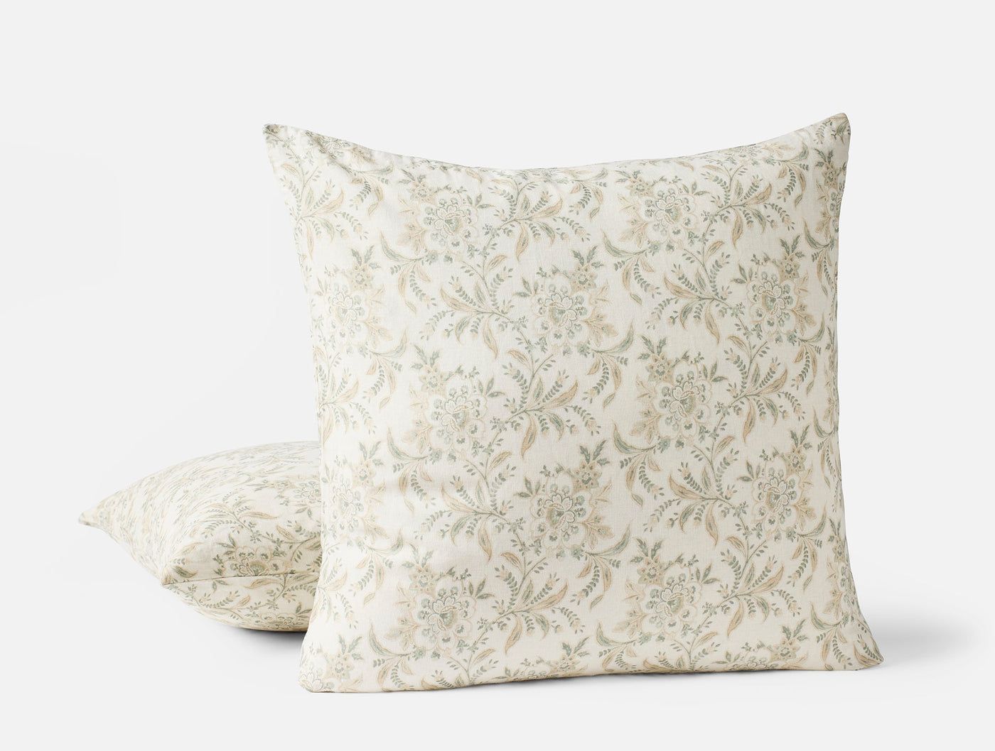 Coyuchi Marguerite Print pillow covers in ivory with sage floral vine pattern, two sizes shown.