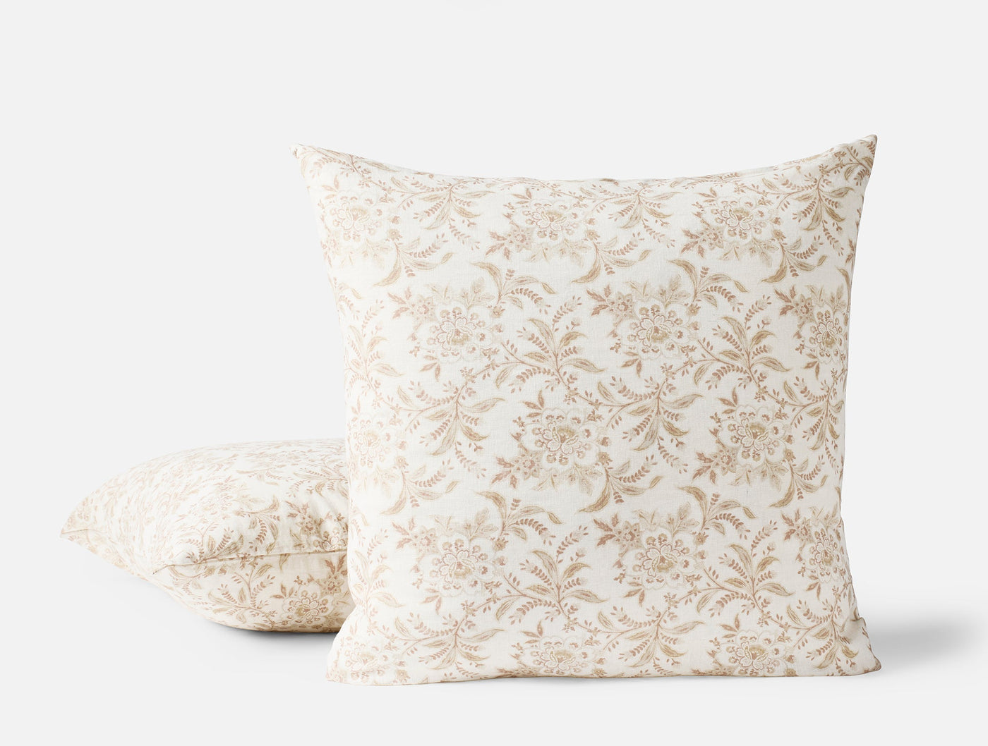 Coyuchi Marguerite Print pillow covers in ivory with tan floral print, two sizes shown.
