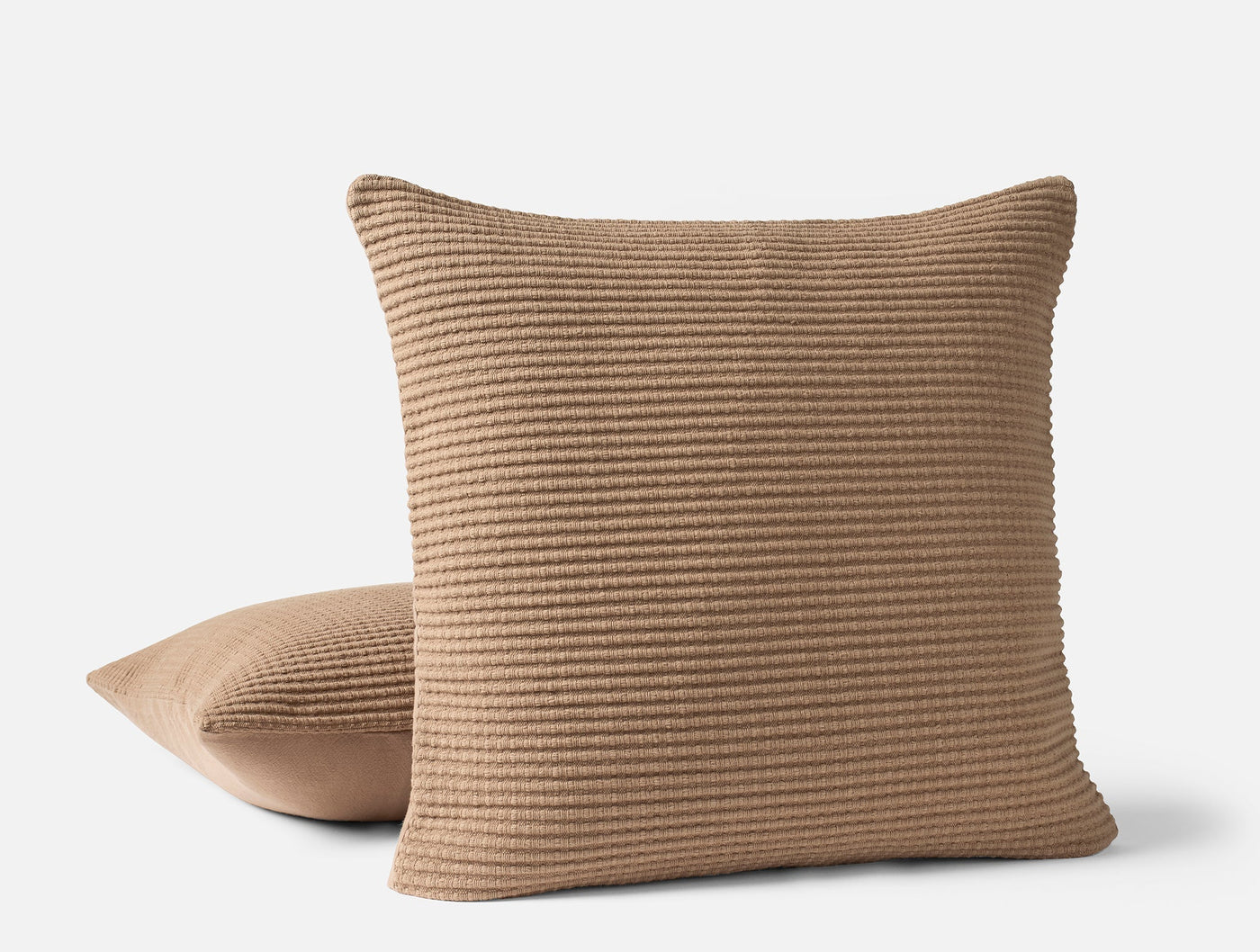 Coyuchi Marshall pillow covers in camel, ribbed texture detail, two cushions stacked.