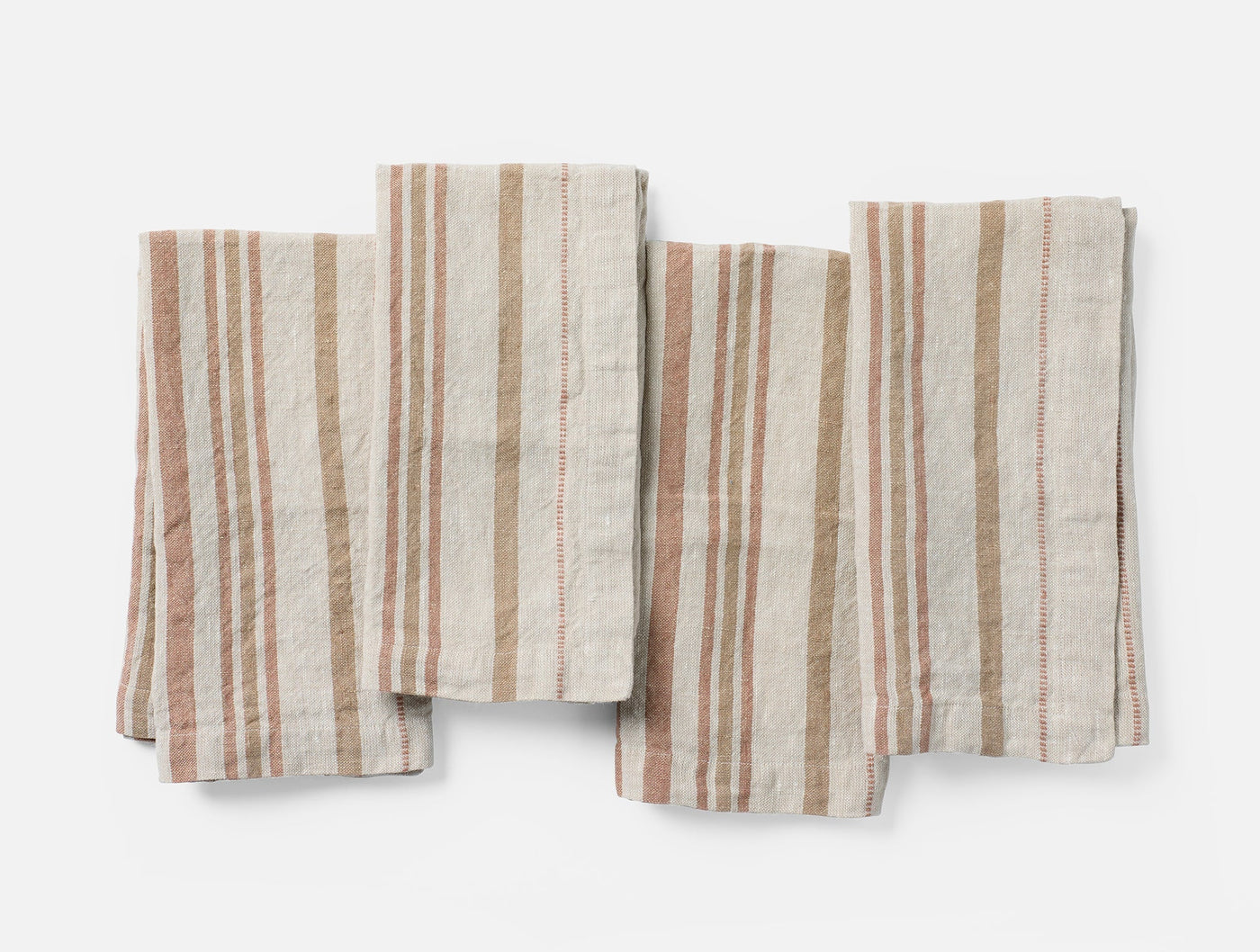Four folded Coyuchi Mojave Linen napkins in terracotta and tan stripe, laid flat overhead.