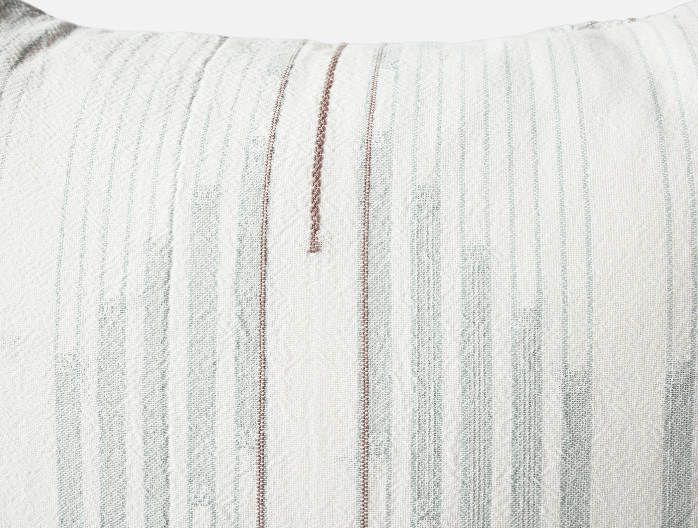 Close-up of Coyuchi Morelia sham showing ivory woven fabric with gray and rose stripe detail.
