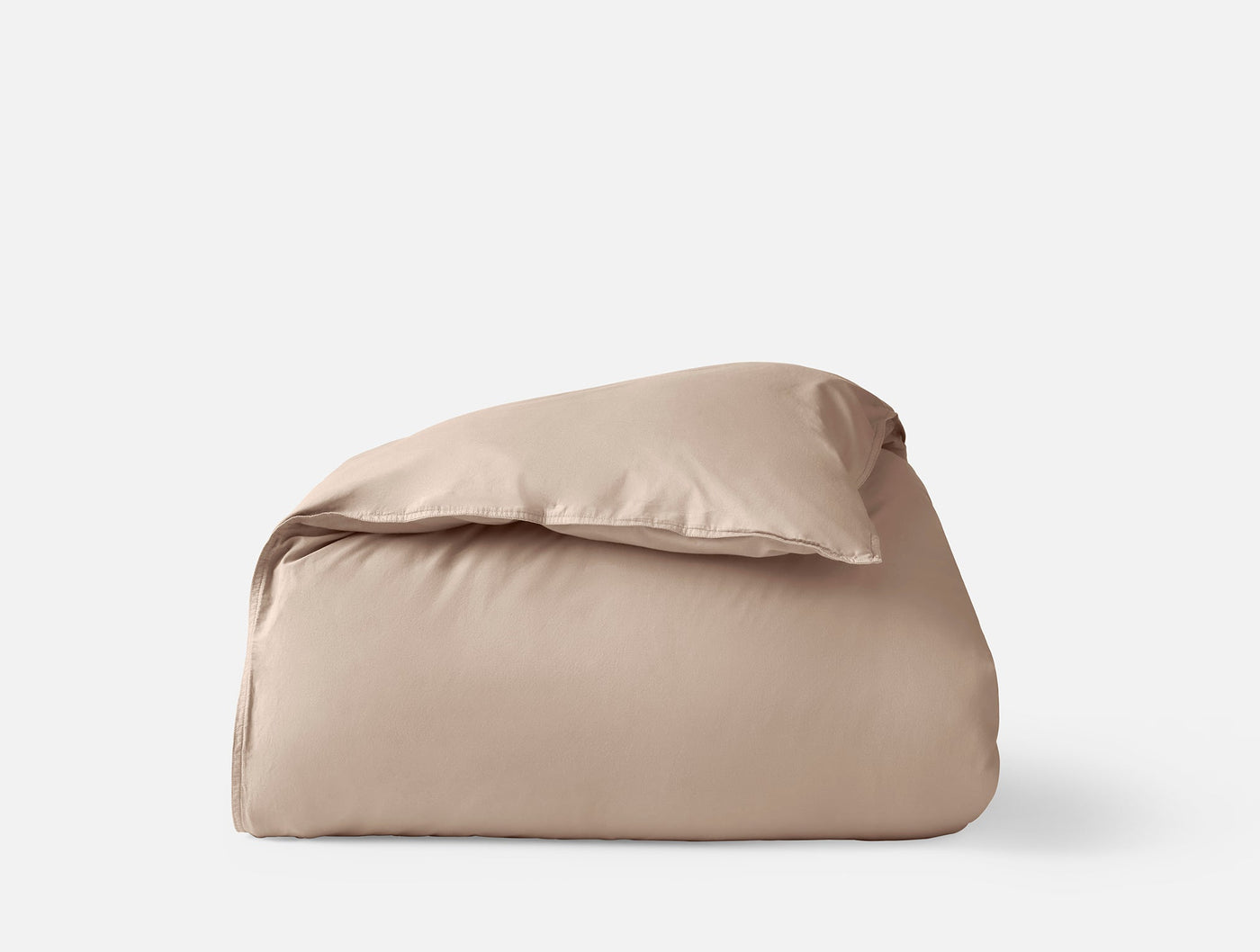 Close-up of folded Coyuchi Crinkled Percale duvet cover in warm taupe against white background.