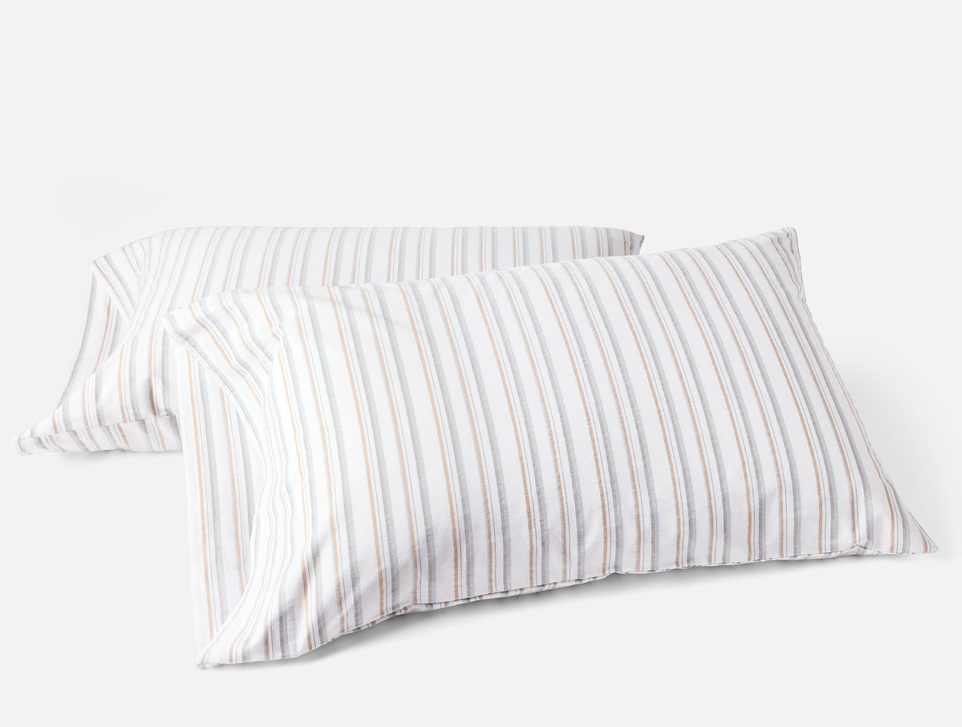 Pair of Coyuchi Crinkled Percale pillowcases with multicolor thin stripes on white.