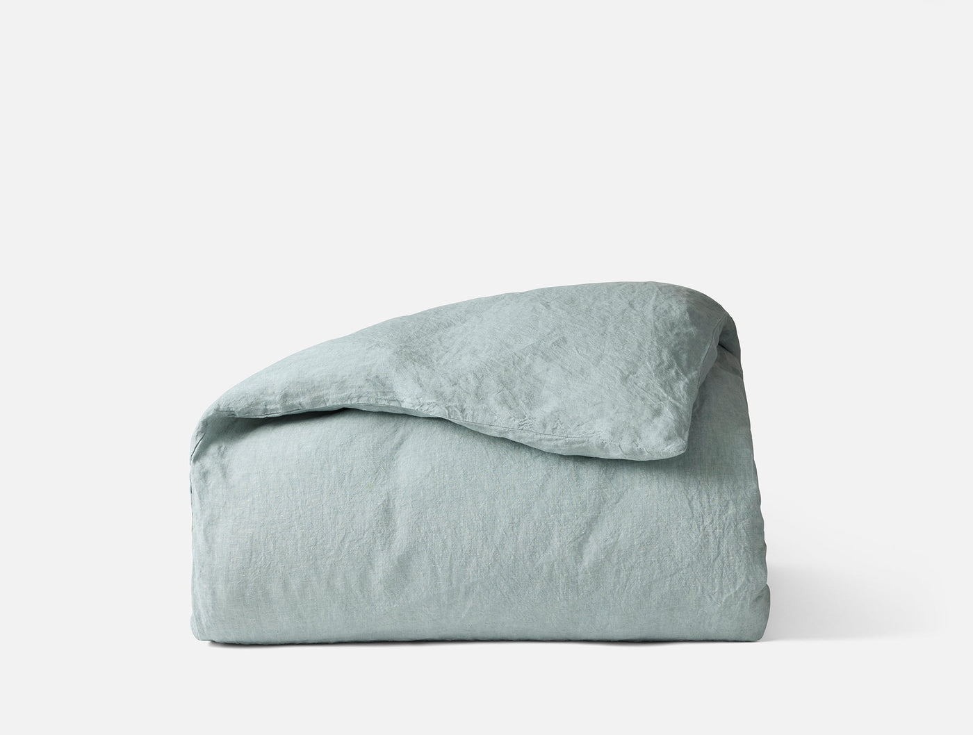 Coyuchi Relaxed Linen duvet cover folded, seafoam, showing natural wrinkled texture.