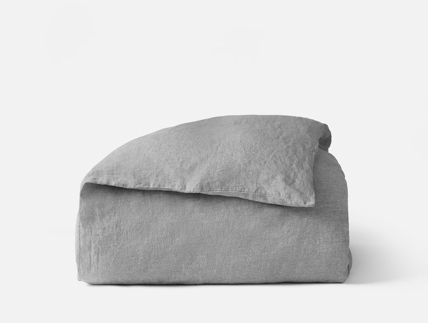 Close-up of folded Coyuchi Relaxed Linen duvet cover in silver-grey, showing textured weave.