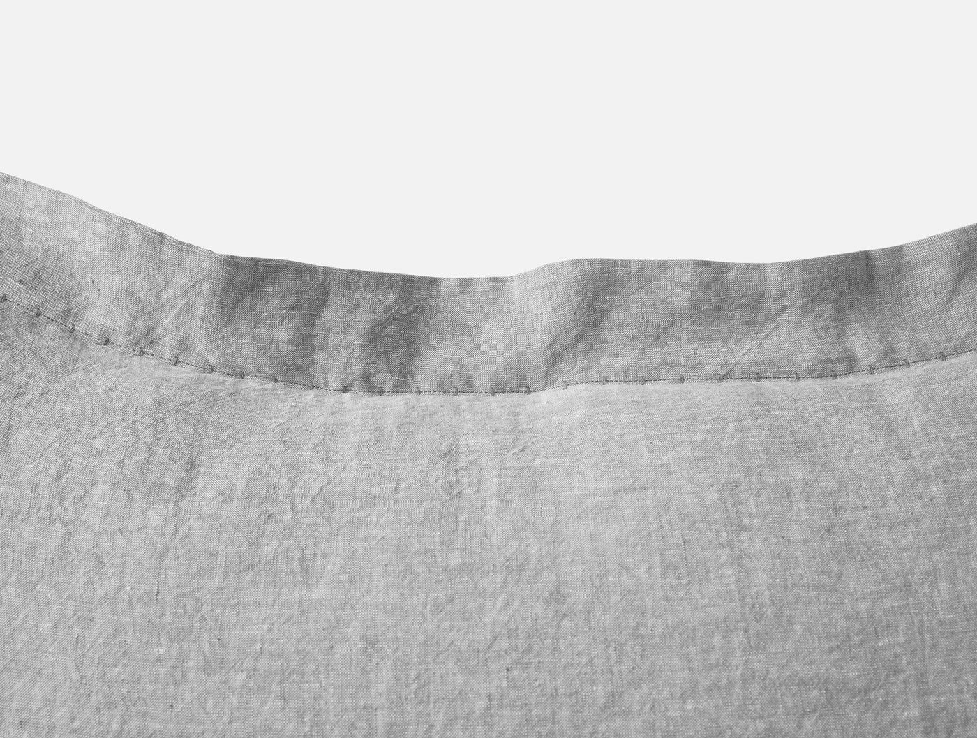 Close-up of Coyuchi Relaxed Linen sham hem in silver grey, showing ruffled edge detail.
