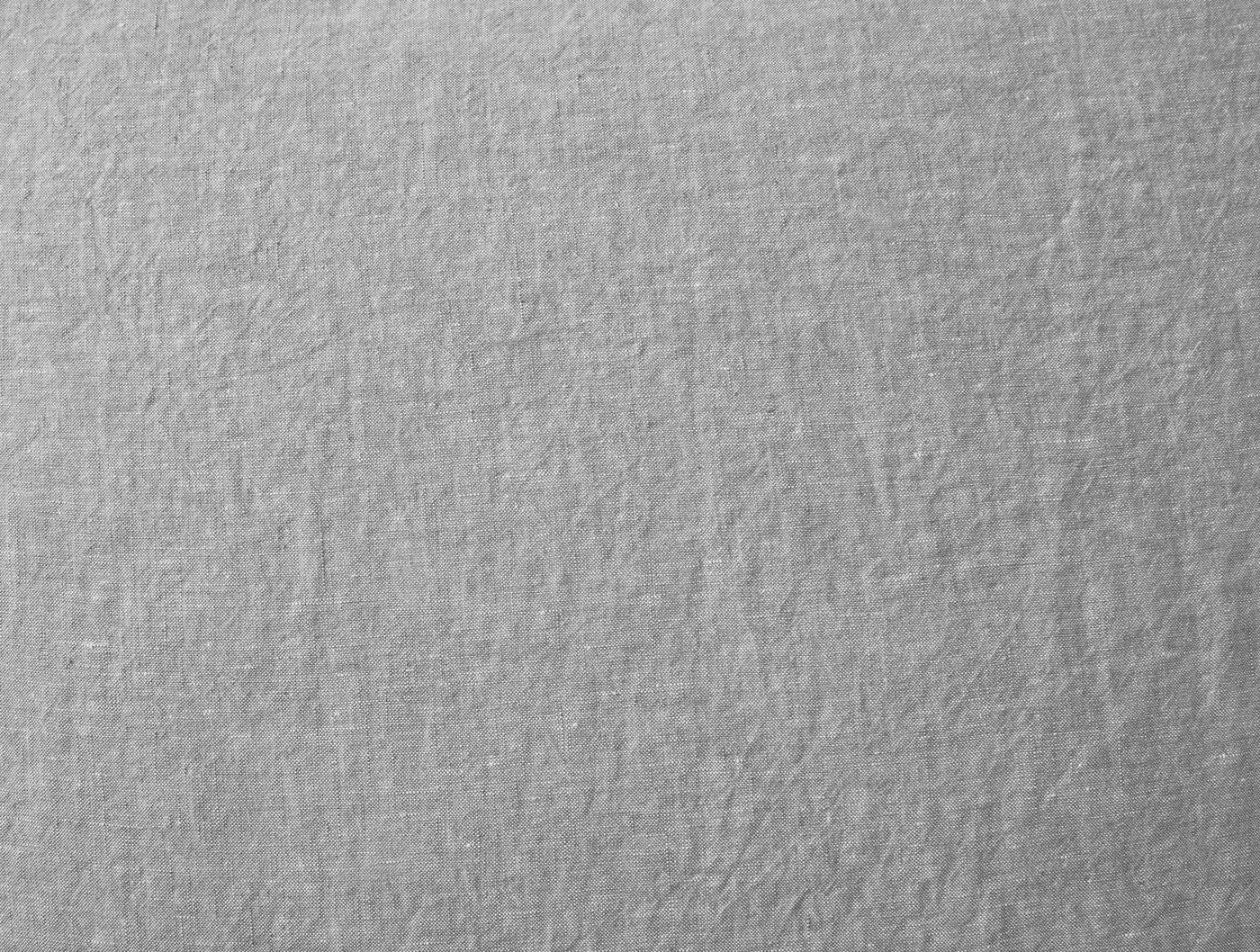 Close-up of Coyuchi Relaxed Linen fabric texture in silver-grey, showing natural wrinkled weave.