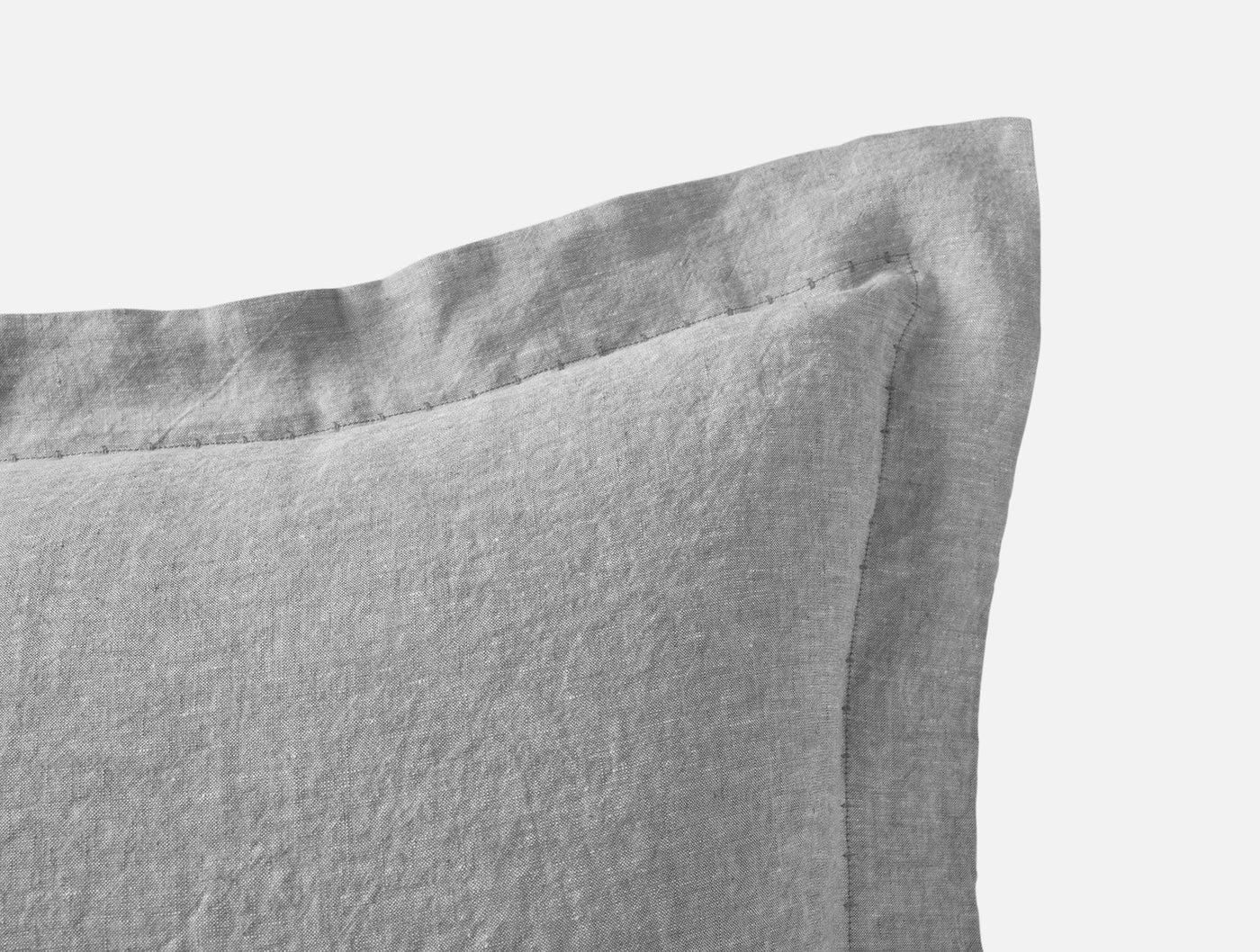 Close-up of Relaxed Linen pillow sham corner detail in grey, showing flanged edge and woven texture.