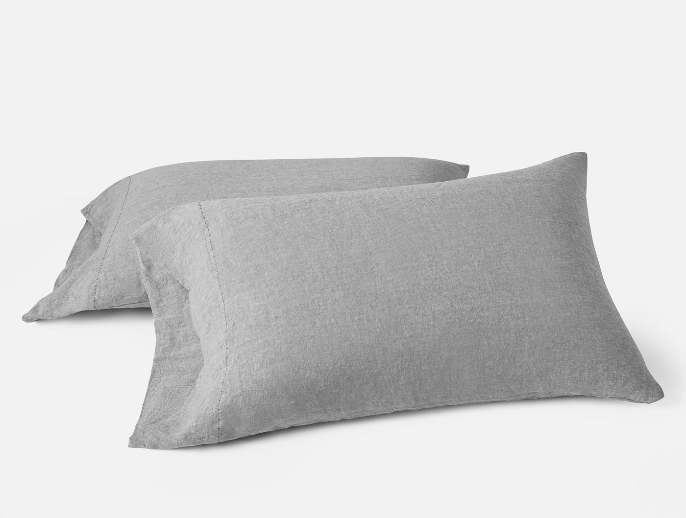 Close-up of two Coyuchi Relaxed Linen pillowcases in heathered gray, stacked at an angle.