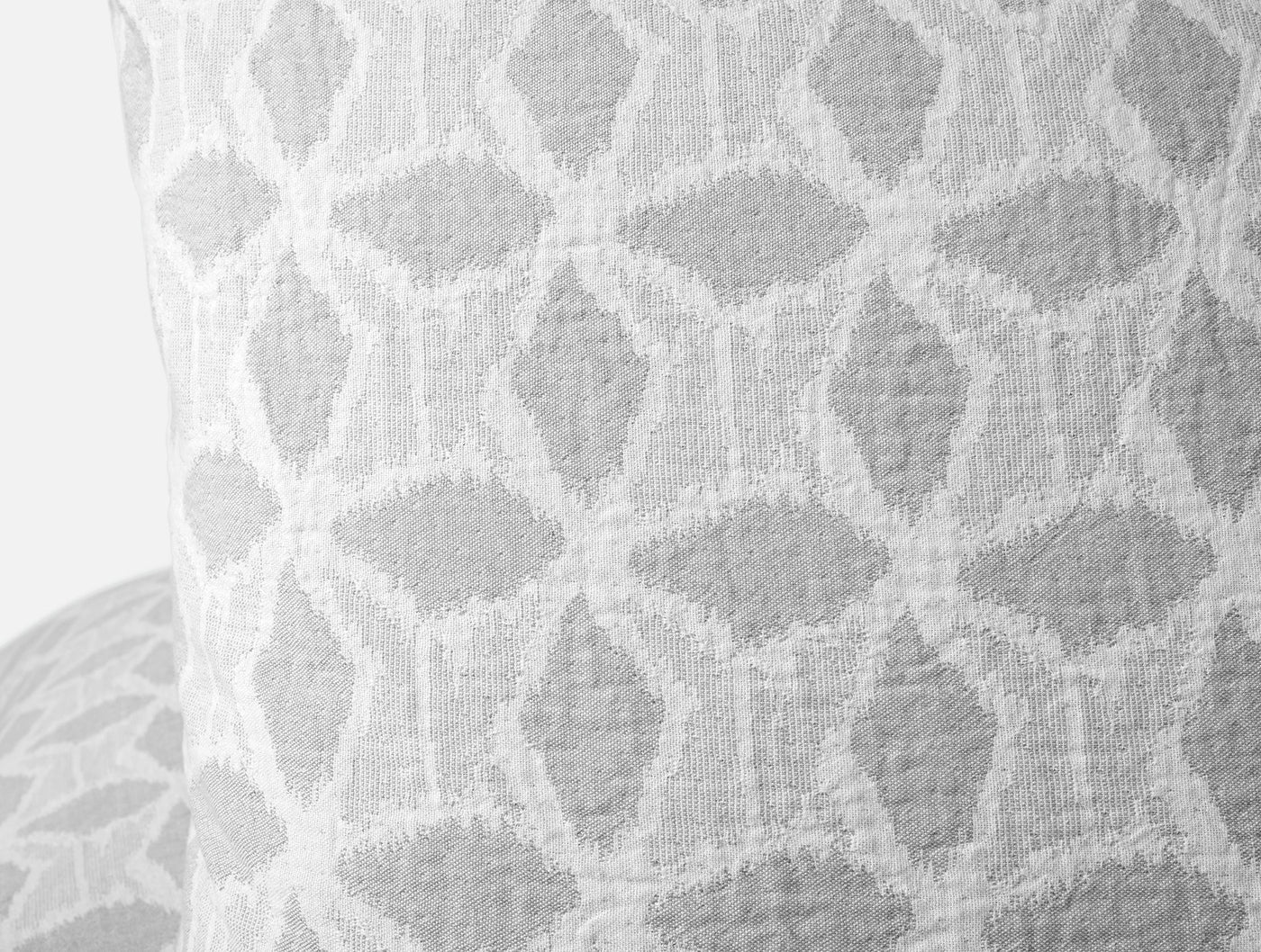 Close-up of Coyuchi Palomar sham in silver, showing woven ogee lattice texture detail.