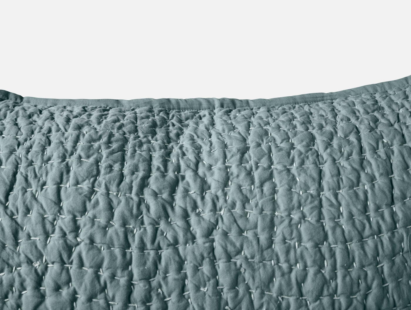 Close-up of Coyuchi Pebbled Handstitched sham in slate blue, showing quilted texture detail.